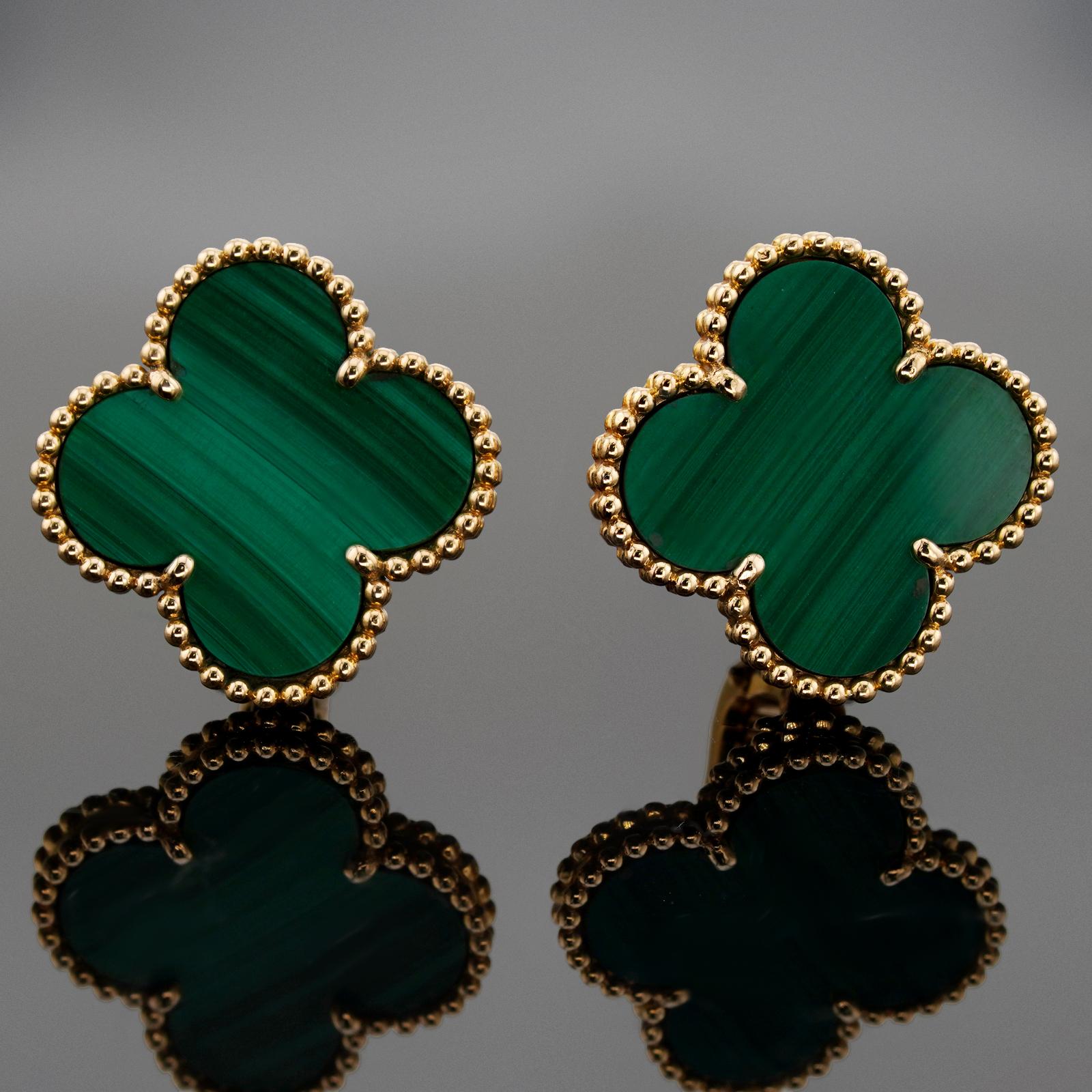These rare Van Cleef & Arpels clip-on earrings from the iconic Magic Alhambra collection are crafted in 18k yellow gold and feature a pair of lucky clover motifs inlaid with green malachite in round bead settings. Made in France circa 2000s.