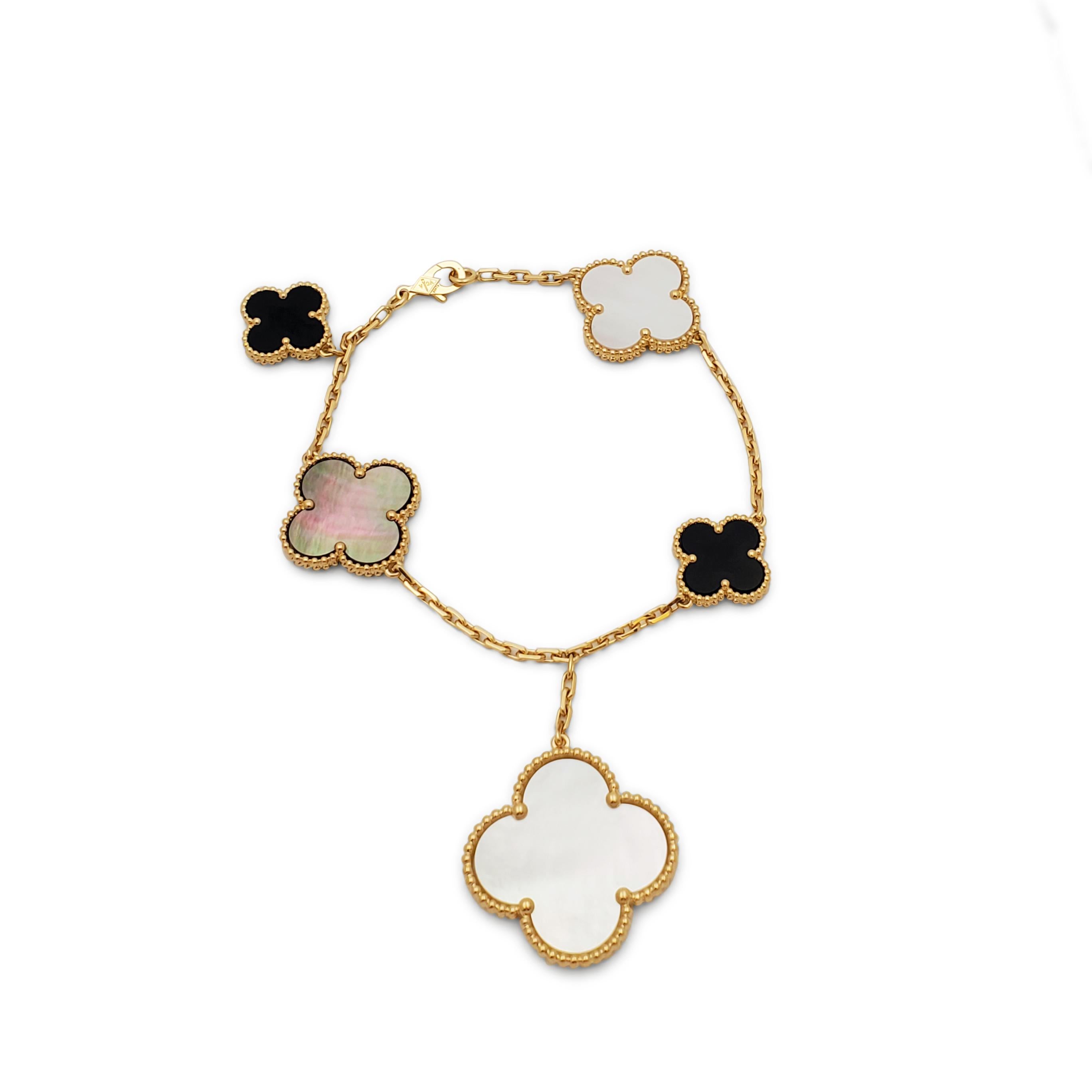 Authentic Van Cleef & Arpels 'Magic Alhambra' bracelet crafted in 18 karat yellow gold. Featuring a joyful mix of 5 clover-shaped onyx, white and gray mother-of-pearl motifs of varying sizes. The bracelet measures 7 1/2 inches in length with