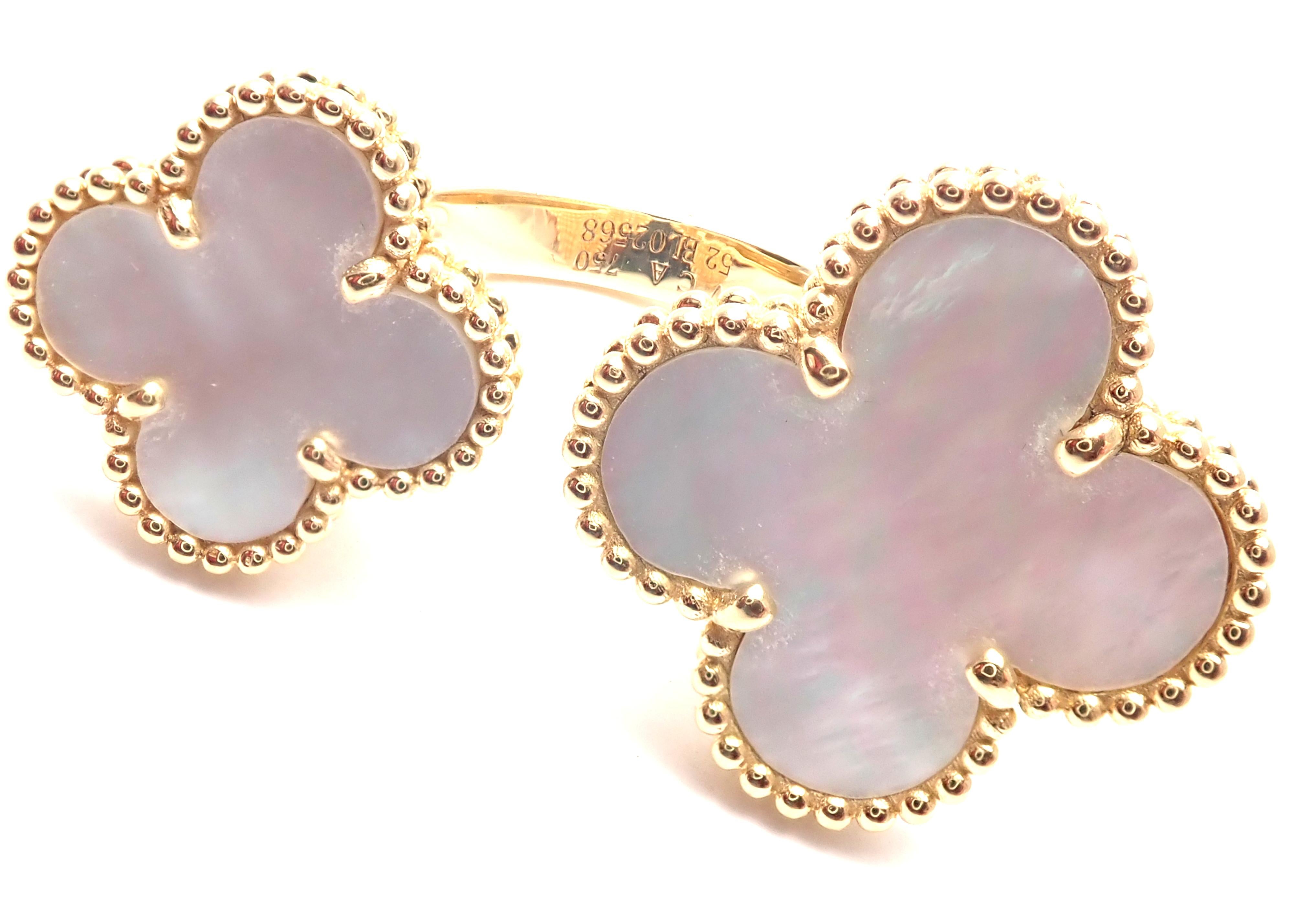 18k Yellow Gold White Mother Of Pearl Alhambra Between The Finger Ring by Van Cleef & Arpels.
With 2 Alhambra shape white mother of pearl stones.
Details:
Size - 6
Width: Larger 20.5mm Smaller 16mm
Weight: 11.9 grams
Stamped Hallmarks:  VCA 750 52