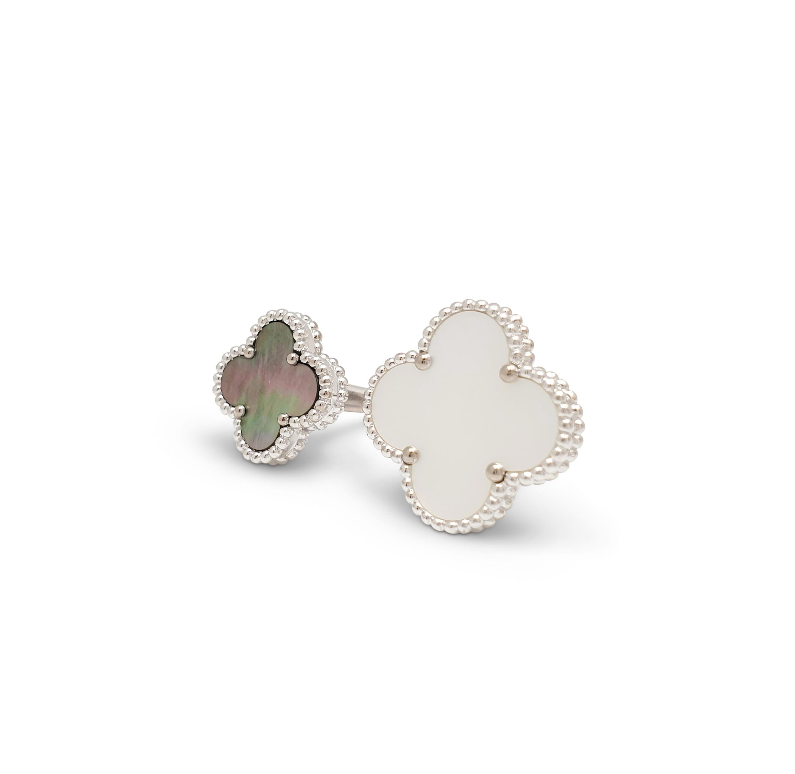 Authentic Van Cleef & Arpels Magic Alhambra between the finger ring crafted in 18 karat white gold and set with two clover-shaped motifs in mother of pearl.  Size 48 (US 4 1/2).  Signed VCA, Au750, with serial number and French hallmarks.  Ring is
