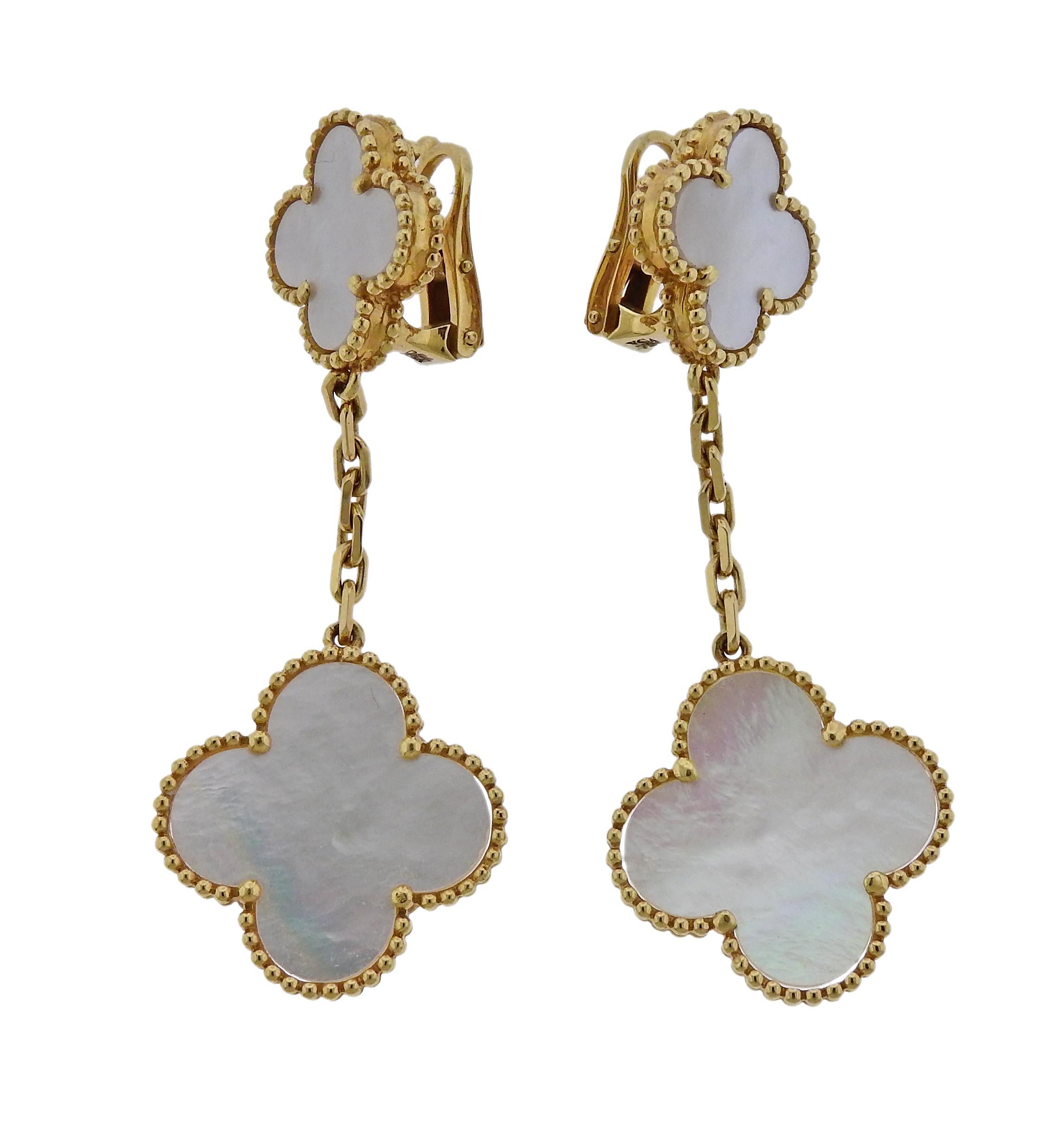 Pair of iconic Magic Alhambra earrings, crafted by Van Cleef & Arpels, set with mother of pearl in 18k yellow gold. Current retail $6200. Earrings are 553mm long x 20mm at widest point and weigh 13.6 grams. Marked BL273***, VCA 750. 