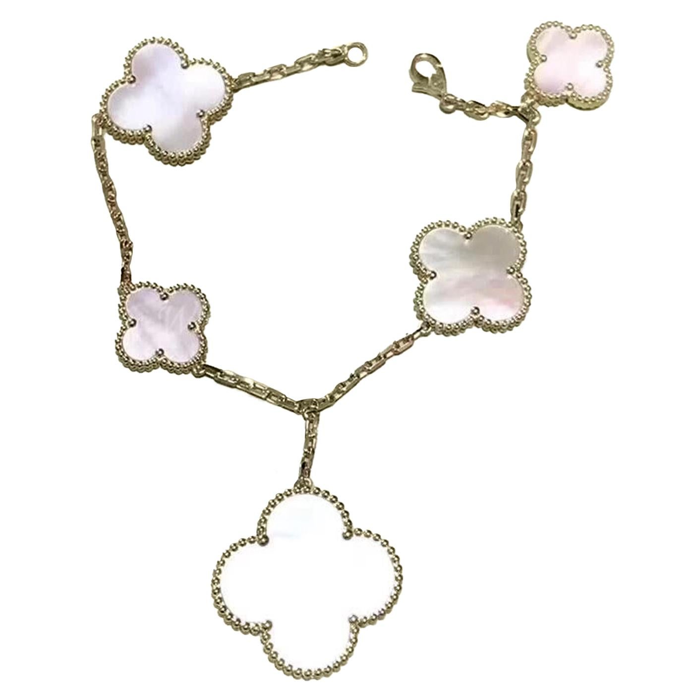 A wonderful Magic Alhambra MOP (Mother of Pearl) Bracelet by Van Cleef & Arpels. In wonderful condition with Original soft Case, pouch, and certificate from Van Cleef & Arpels, Harrods. Each quatrefoil is set with a perfect disc of MOP. Signed VCA,