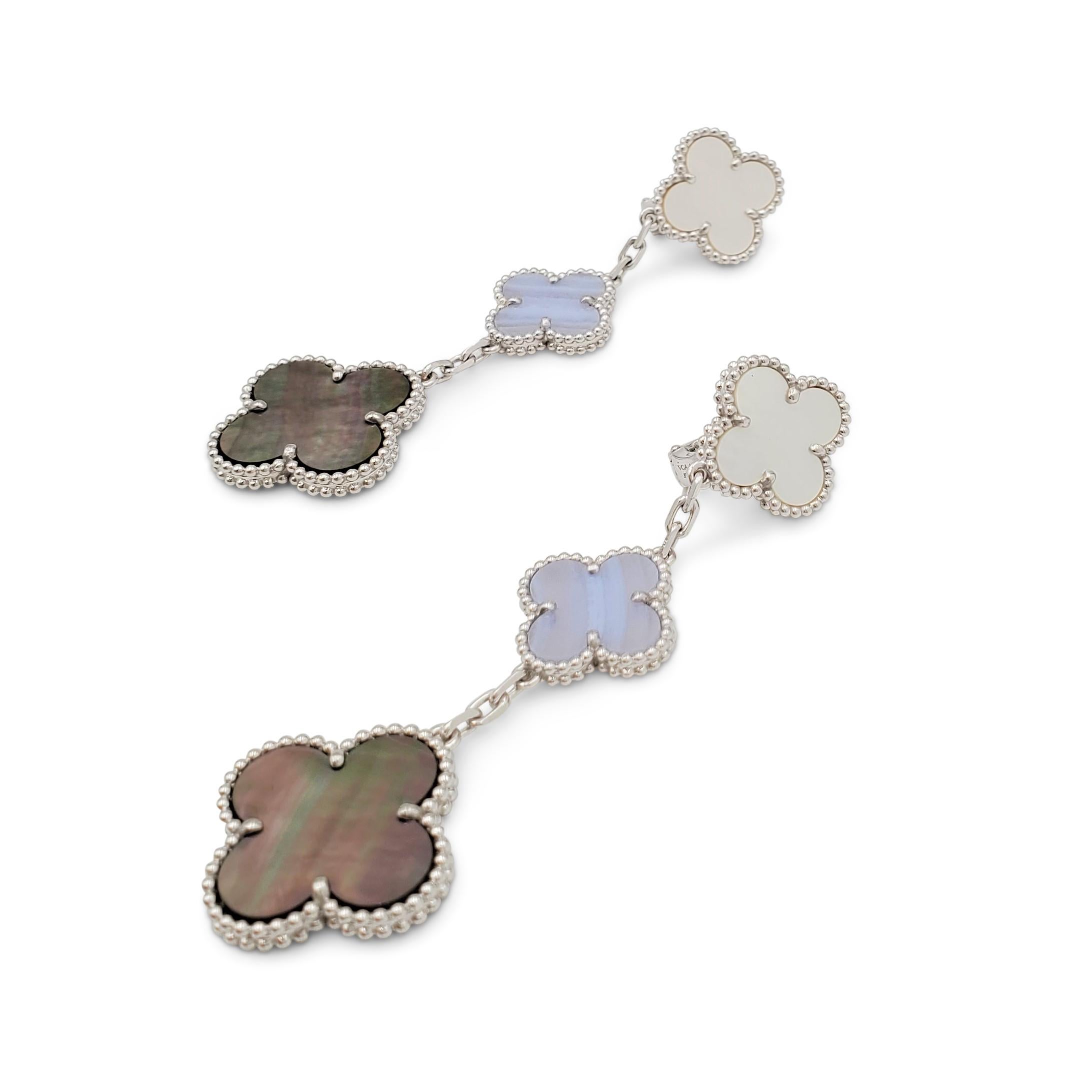 Authentic Van Cleef & Arpels 'Magic Alhambra' earrings crafted in 18 karat white gold feature three different sized motifs inspired by the cloverleaf in chalcedony and mother-of-pearl. Signed VCA, Au750, with serial number and hallmark. The earrings