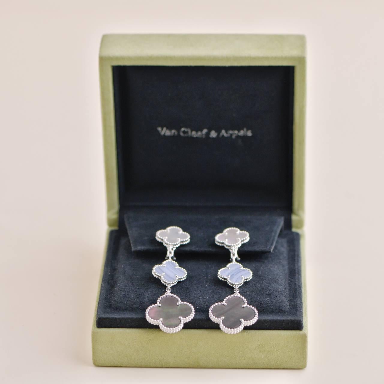 *Rare Find*

Exude elegance with these stunning Magic Alhambra earrings from Van Cleef & Arpels. Crafted from 18k white gold, this exquisite pair showcases three motifs featuring a harmonious blend of mother of pearl and Chalcedony. The delicate and