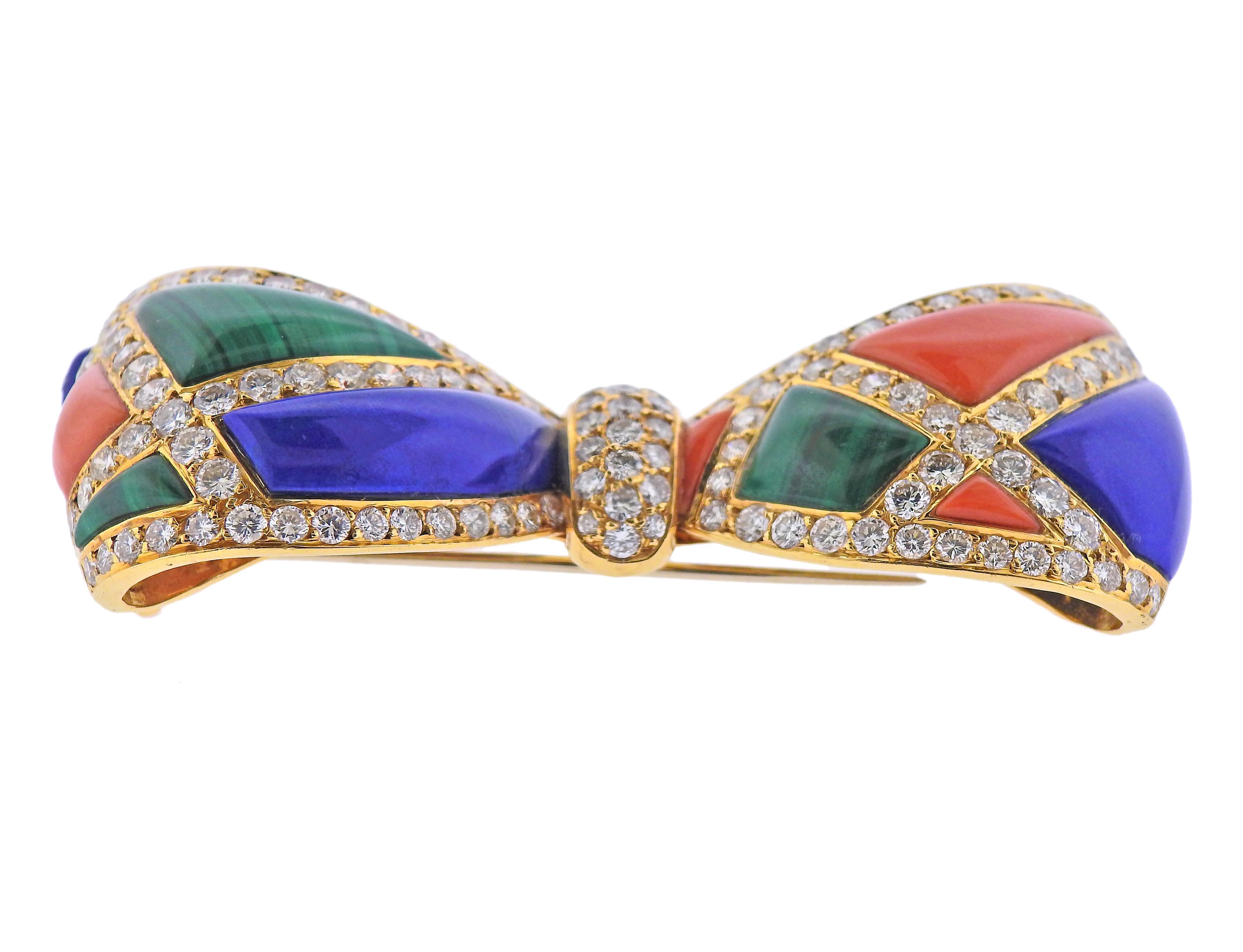 18k gold bow brooch by Van Cleef & Arpels, with lapis, malachite, coral and approx. 4.50-5.00ctw in diamonds. Brooch measures 2.5