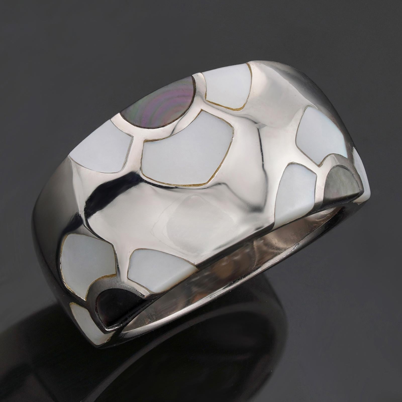 This gorgeous Van Cleef & Arpels ring is crafted in 18k white gold and inlaid with white and gray mother-of-pearl. Made in France circa 2000s. Measurements: 0.47