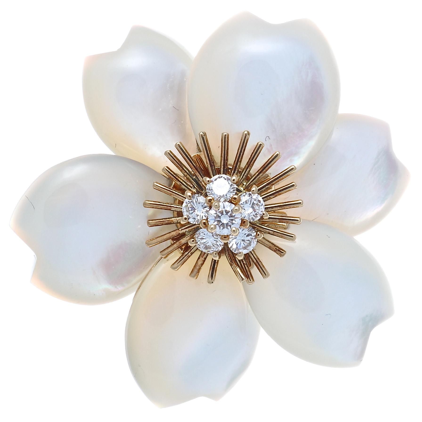 Spectacular mother of pearl flower earrings by Van Cleef & Arpels. Featuring exquisitely carved mother of pearl petals with diamonds in the center. The 10 round brilliant diamonds are bright white D-F color and VVS+ clarity. The earring is 1 1/2