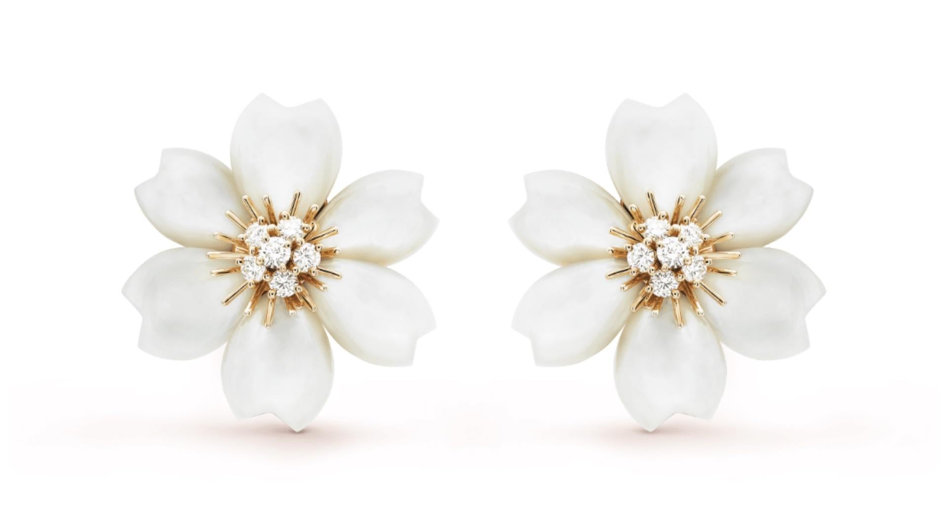 Van Cleef & Arpels Pair of Gold, Mother-of- Pearl and Diamond
'Rose de Noel' Ear-clips, France, crafted in 18k yellow gold, each flower consists of six heart shaped mother of pearl petals, centered with a floret of 6 round brilliant cut diamonds. 12