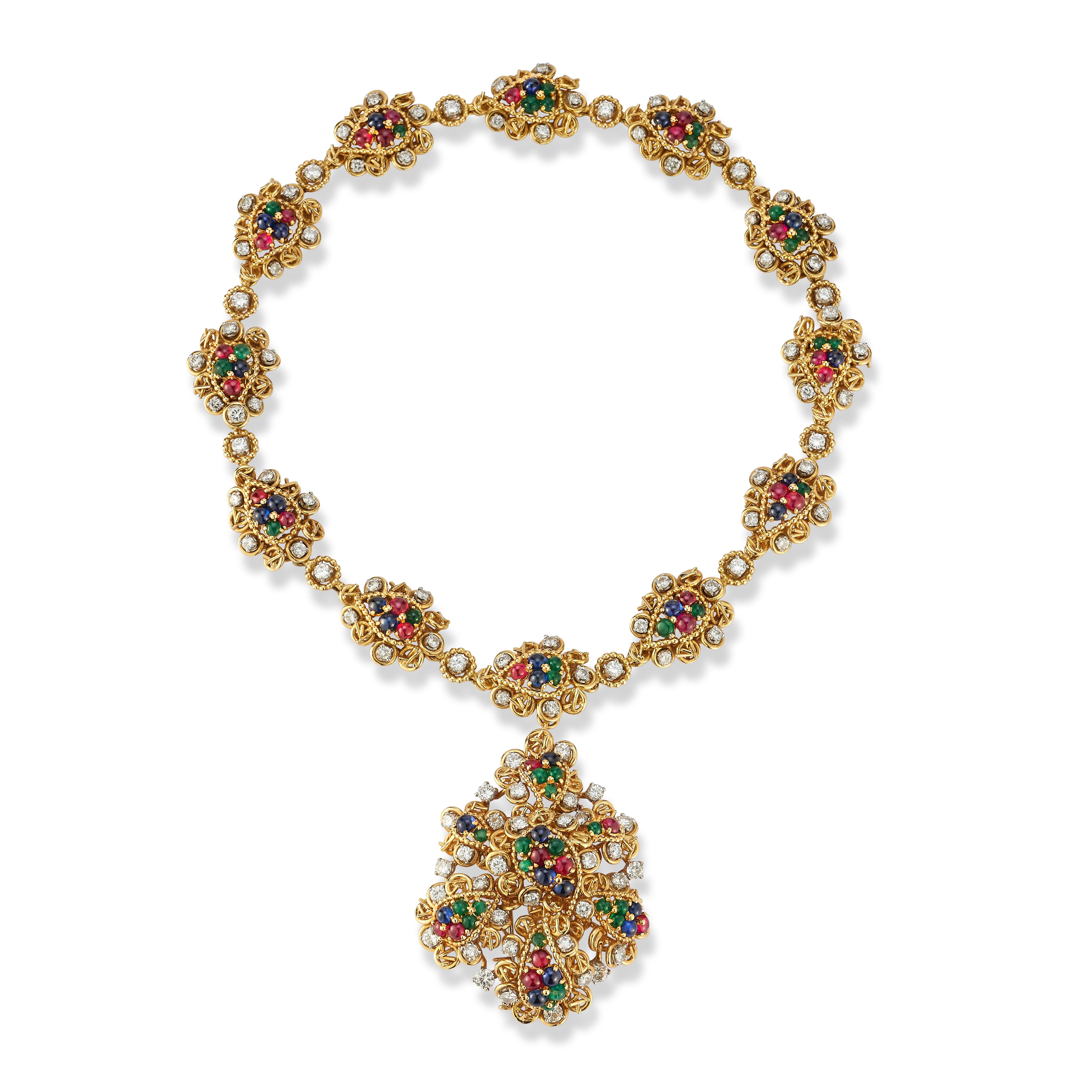 Van Cleef & Arpels Multi Gem Pendant Necklace

An 18-karat yellow gold necklace set with round cut diamonds, cabochon rubies, cabochon sapphires, and cabochon emeralds. The pendant can be removed and worn separately as a brooch and the necklace
