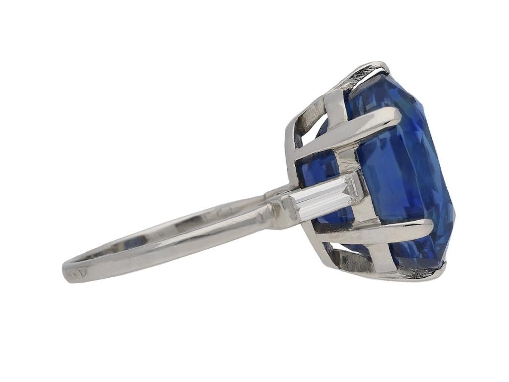 Van Cleef & Arpels Burmese sapphire ring. Set with one cushion shape old cut natural unenhanced Burmese sapphire in an open back claw setting with an approximate weight of 13.36 carats, further set with two rectangular baguette cut diamonds in open
