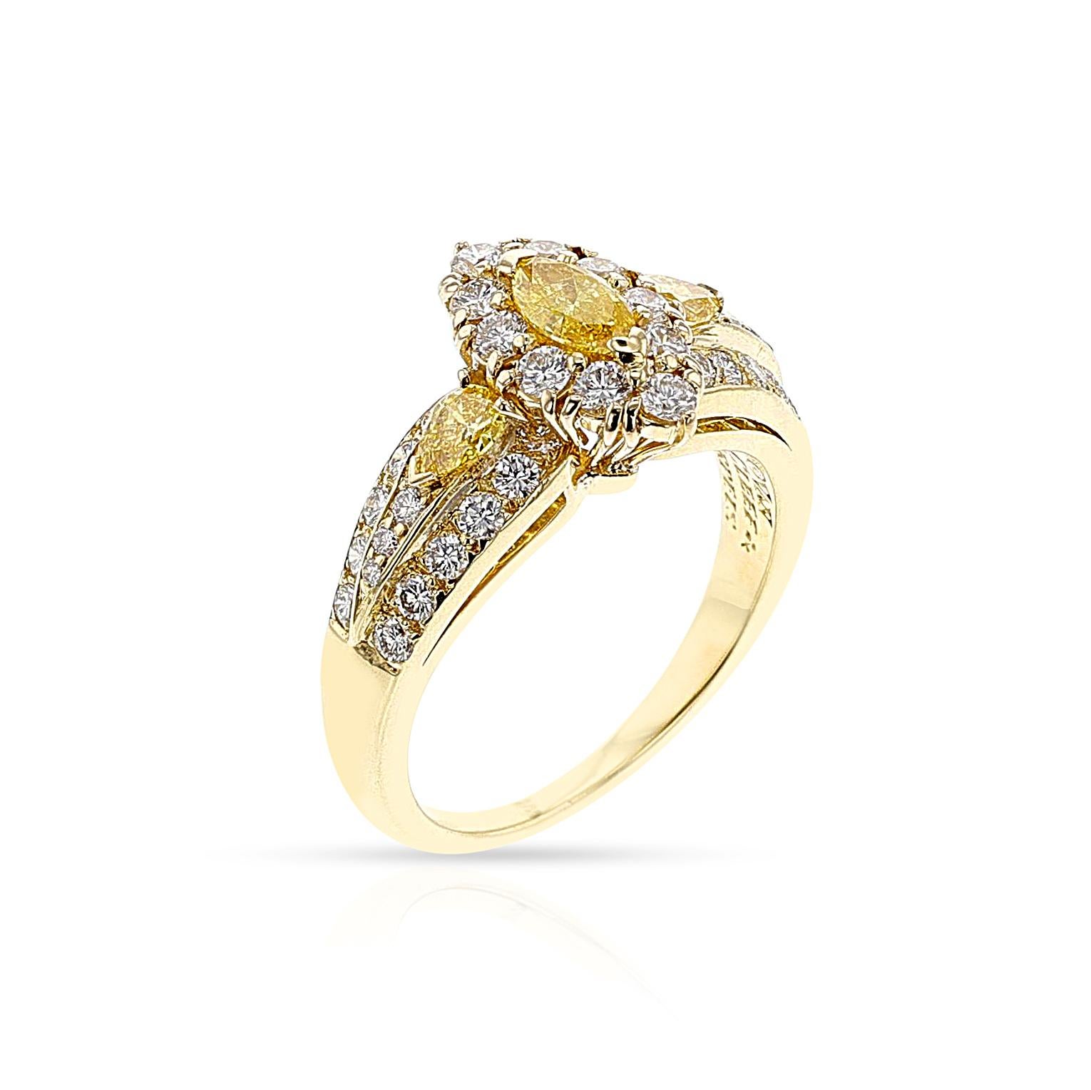 A beautiful and elegant natural diamond ring by Van Cleef & Arpels. This Van Cleef & Arpels creation is set with a natural marquise-shaped yellow diamond appx. 0.25 carats flanked by two smaller pear-shaped yellow diamonds appx. 0.10 carats, which