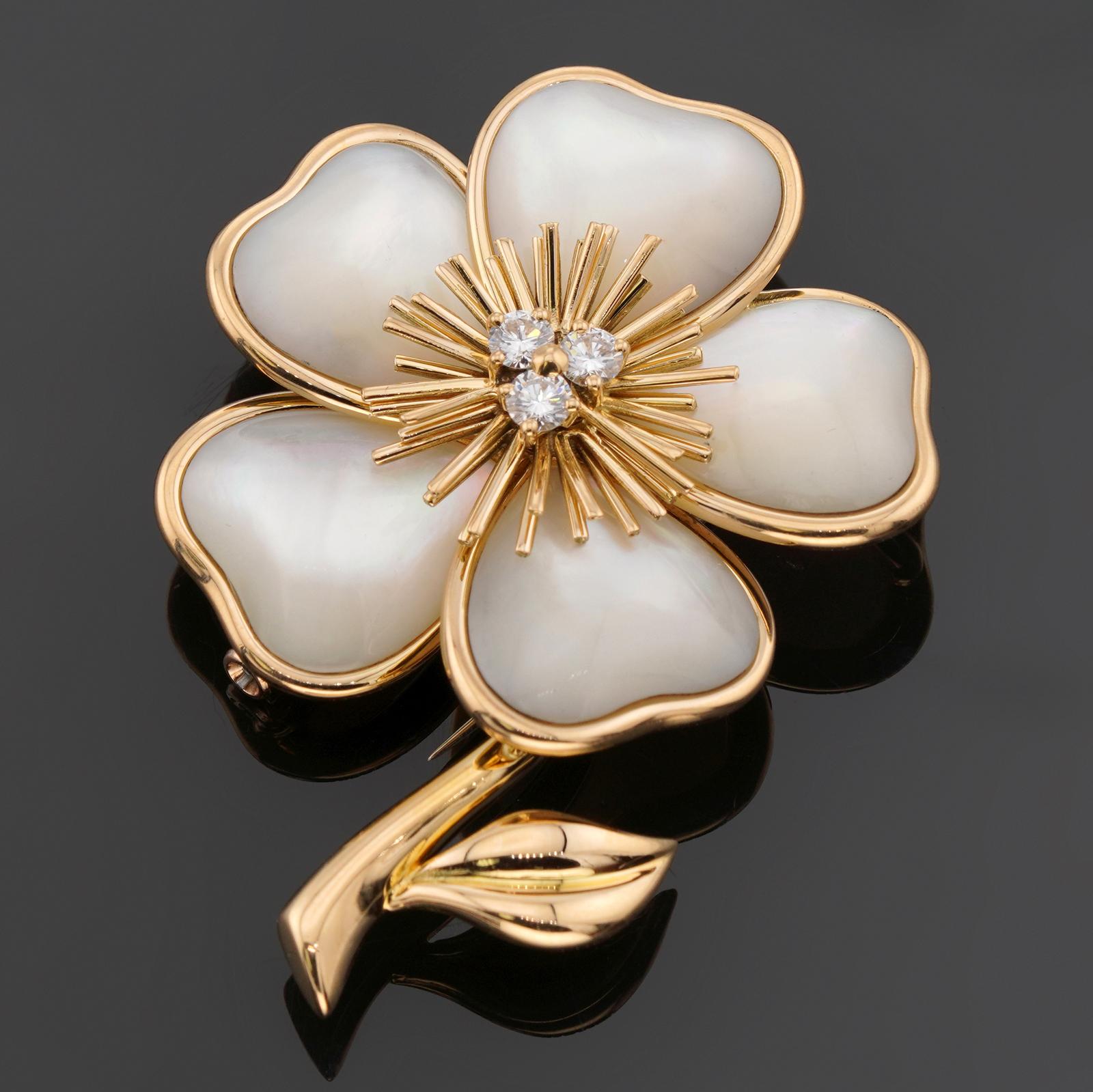 This fabulous Van Cleef & Arpels brooch from the classic Nerval collection features a flower design crafted in 18k yellow gold with white mother-of-pearl petals and 3 brilliant-cut round diamonds. Made in France circa 1990s. Measurements: 1.45