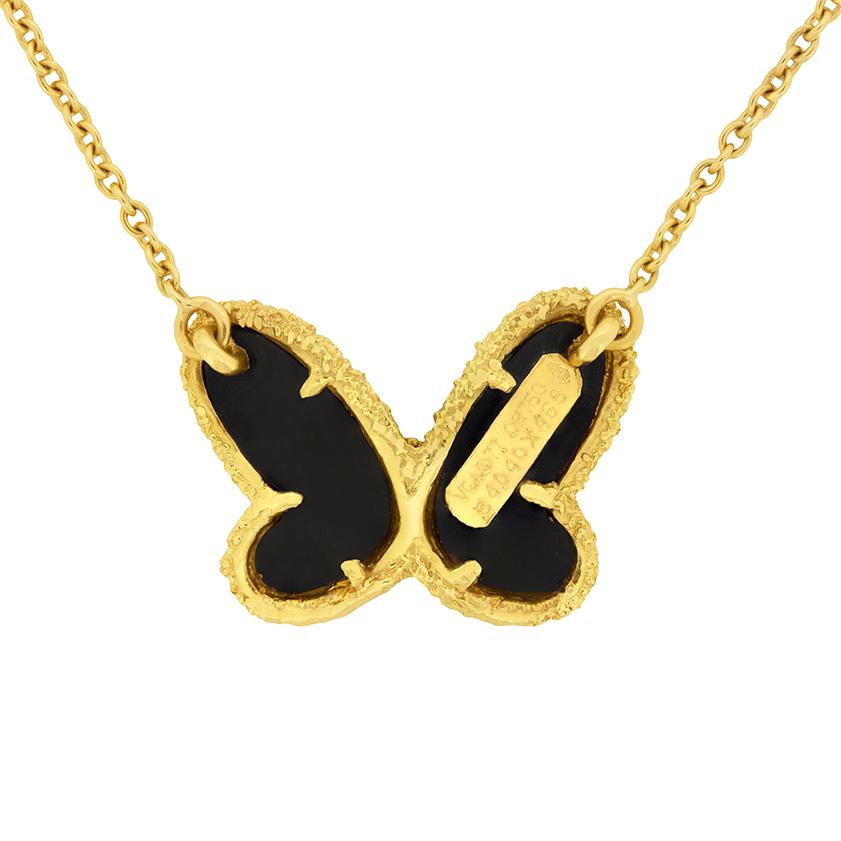 This playful Van Cleef & Arpels butterfly necklace is crafted out of carved black onyx. One round brilliant diamond is set on the butterfly's body. It is 0.02 carat and is F colour and VS clarity. The butterfly is finished in 18 carat yellow gold