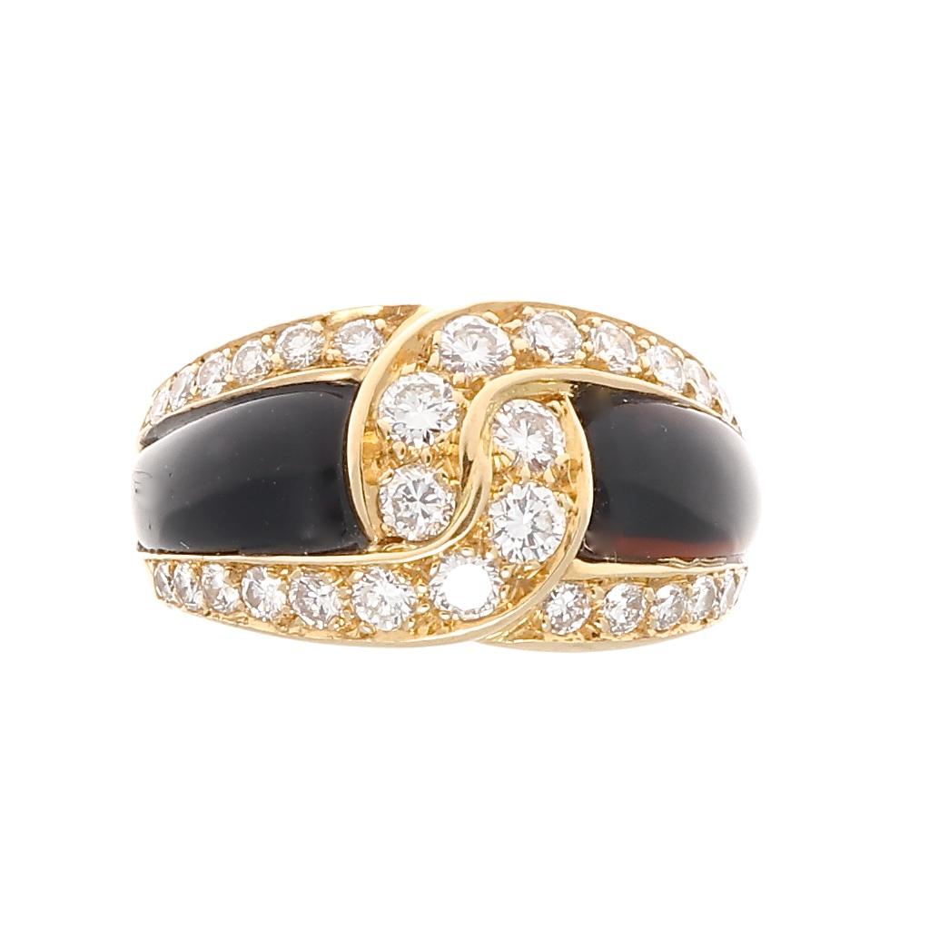 Paris, shopping at VCA, wine with lunch, an afternoon affair - as memorable as this ring. Featuring swooping lines of colorless diamonds tying together the jet black onyx. Crafted in glistening 18k yellow gold. Signed VCA, numbered and stamped with