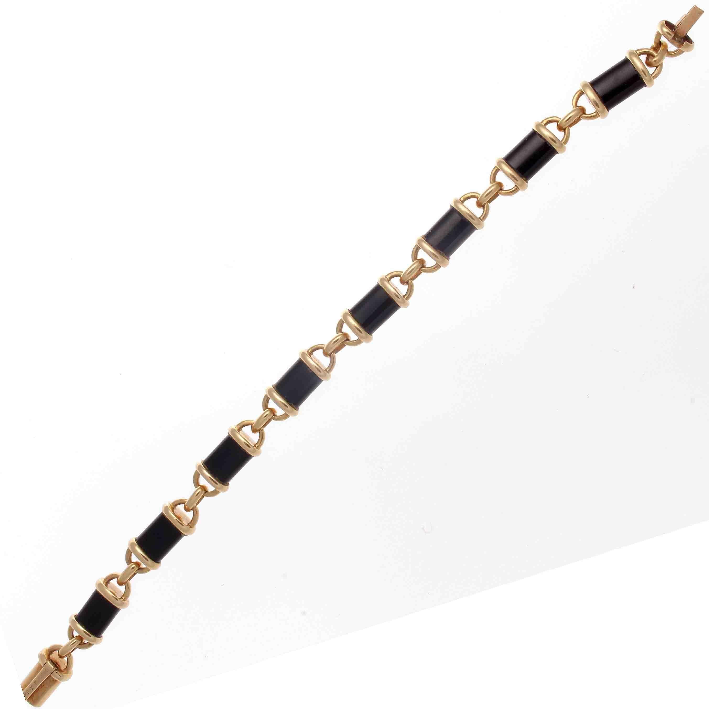 Style effortlessly radiates from each of Van Cleef and Arpels creations. Designed with cylinders of jet black onyx interconnected by links of glistening 18k yellow gold. A classic combination. Signed VCA, numbered and stamped with French hallmarks.