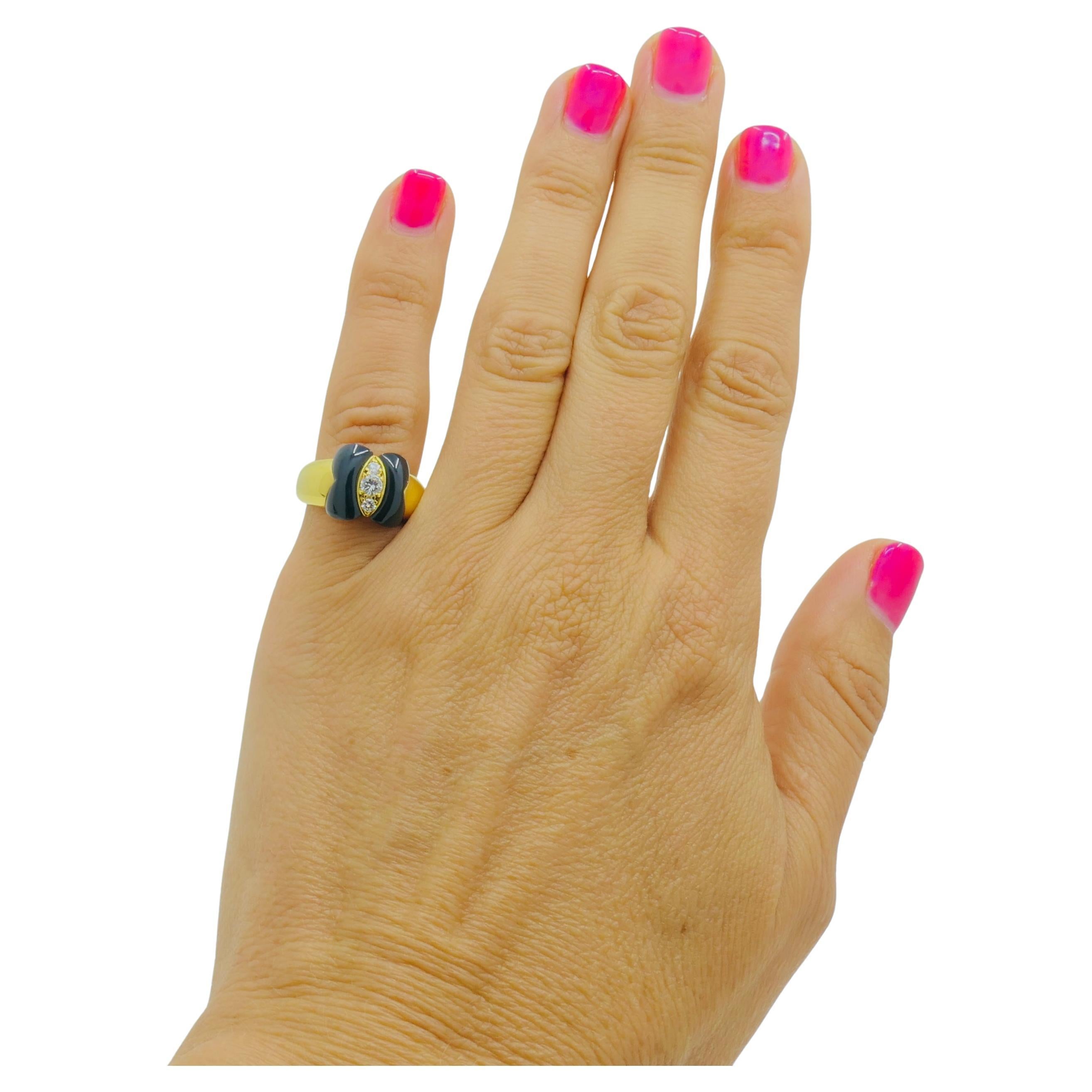 A feminine Van Cleef & Arpels onyx ring, made of 18k gold, featuring diamonds.
This VCA butterfly ring, also known as the Papillon ring, has a perfect balance of bold and
elegant. With rich black onyx framing three sparkling diamonds, it’s a