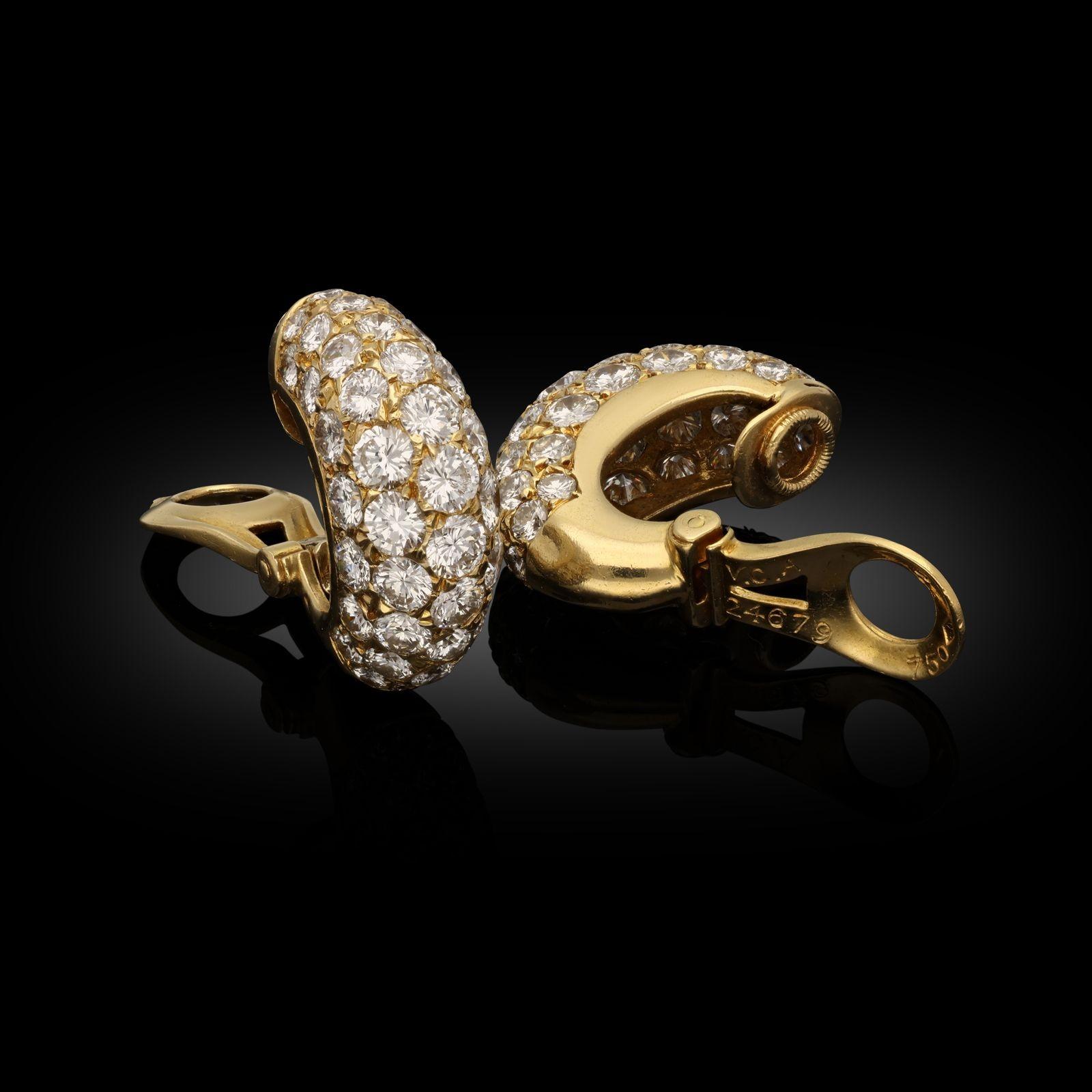 A beautiful pair of diamond hoop earrings by Van Cleef and Arpels c.1974, each earring designed as a high domed half-hoop earring in 18ct yellow gold pavé set with five rows of round brilliant cut diamonds, to post and clip fittings.  These
