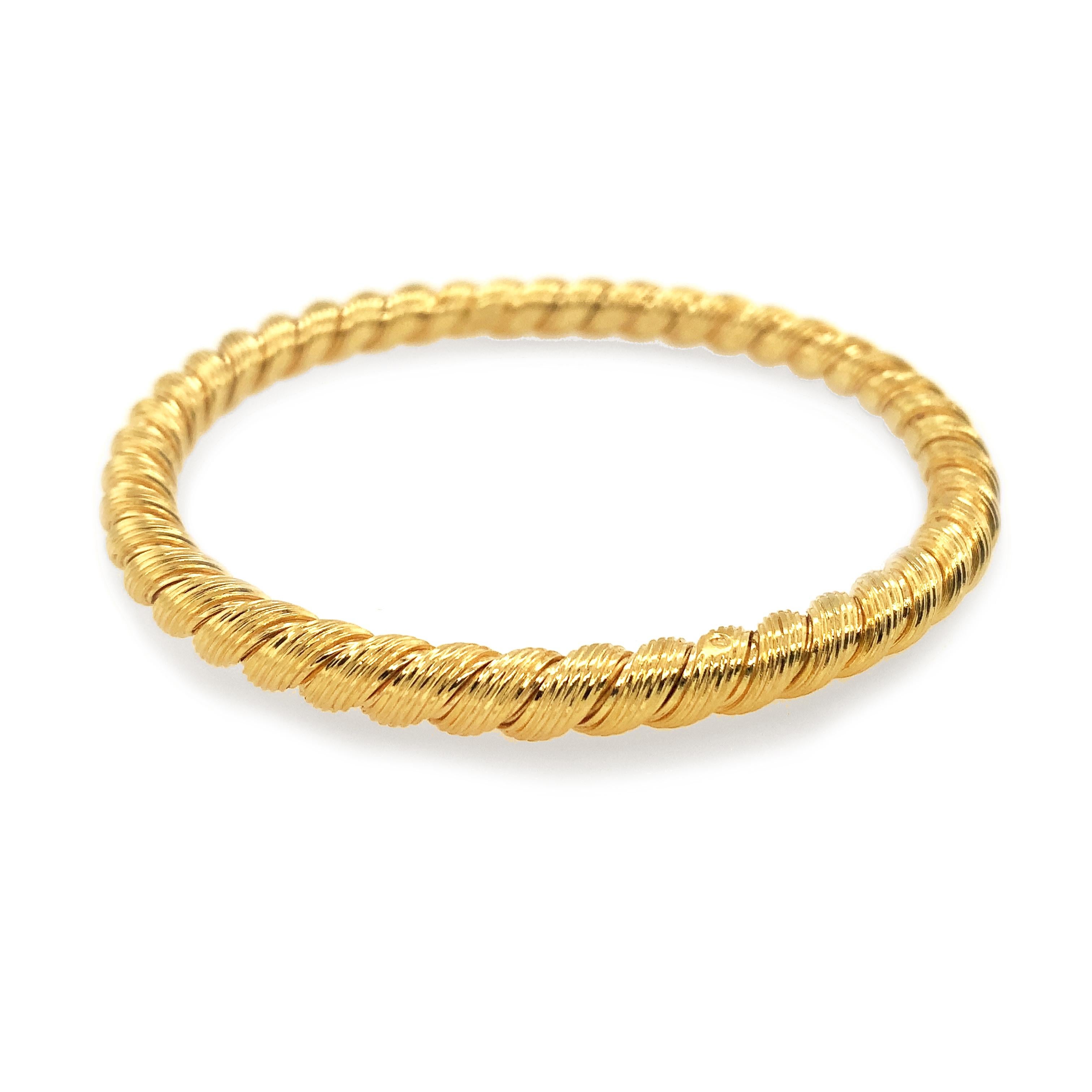 Elegant set of two bangle bracelets.  Made and signed by VAN CLEEF & ARPELS France.  Softly shimmering 18K yellow gold.  Each bracelet is hand woven, in a subtle line pattern and twisted to create a rope pattern.  The bracelets have a slightly