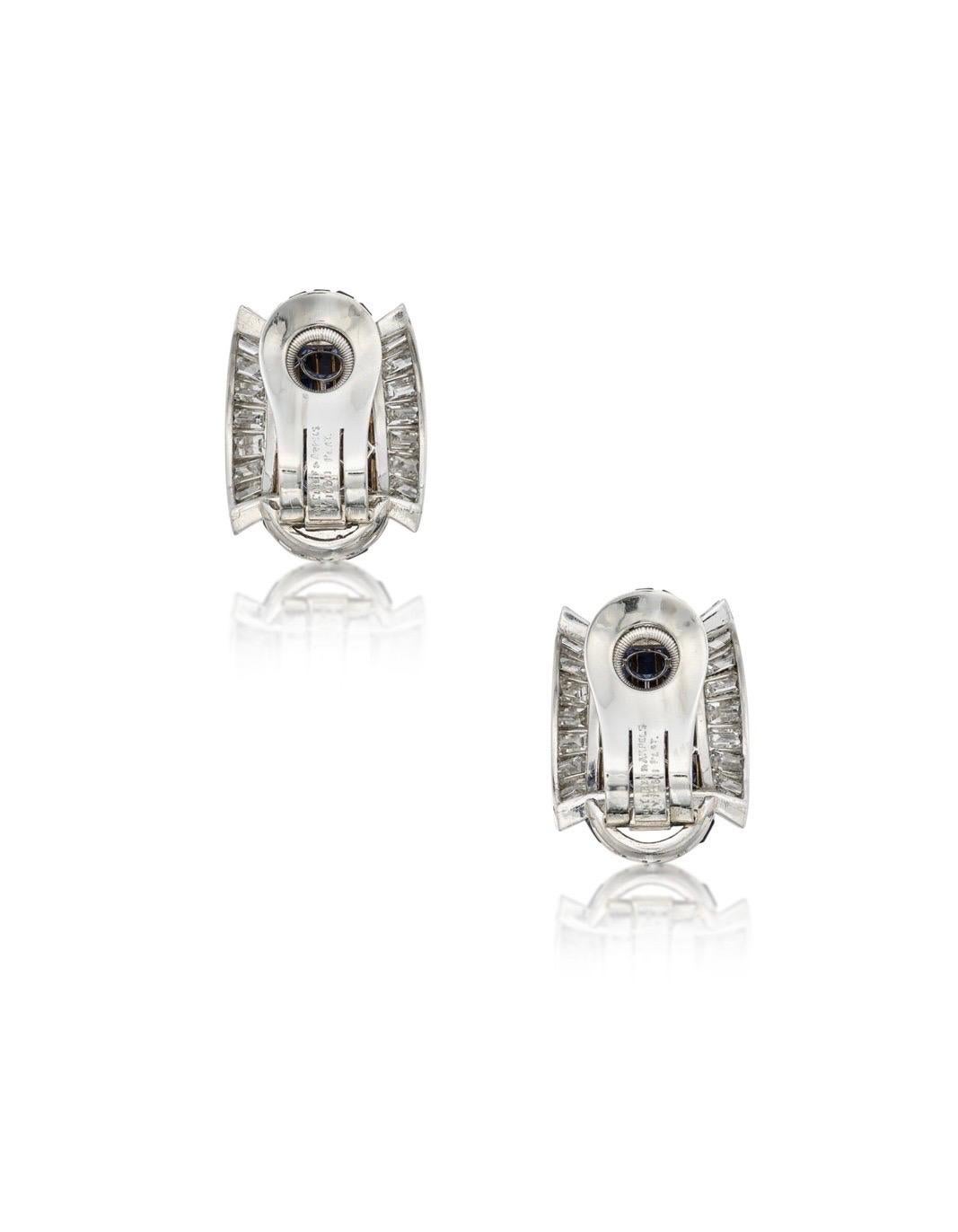 Original VCA earrings of calibré-cut sapphires, bordered by baguette diamonds, signed Van Cleef & Arpels, numbered N.Y.10511. 