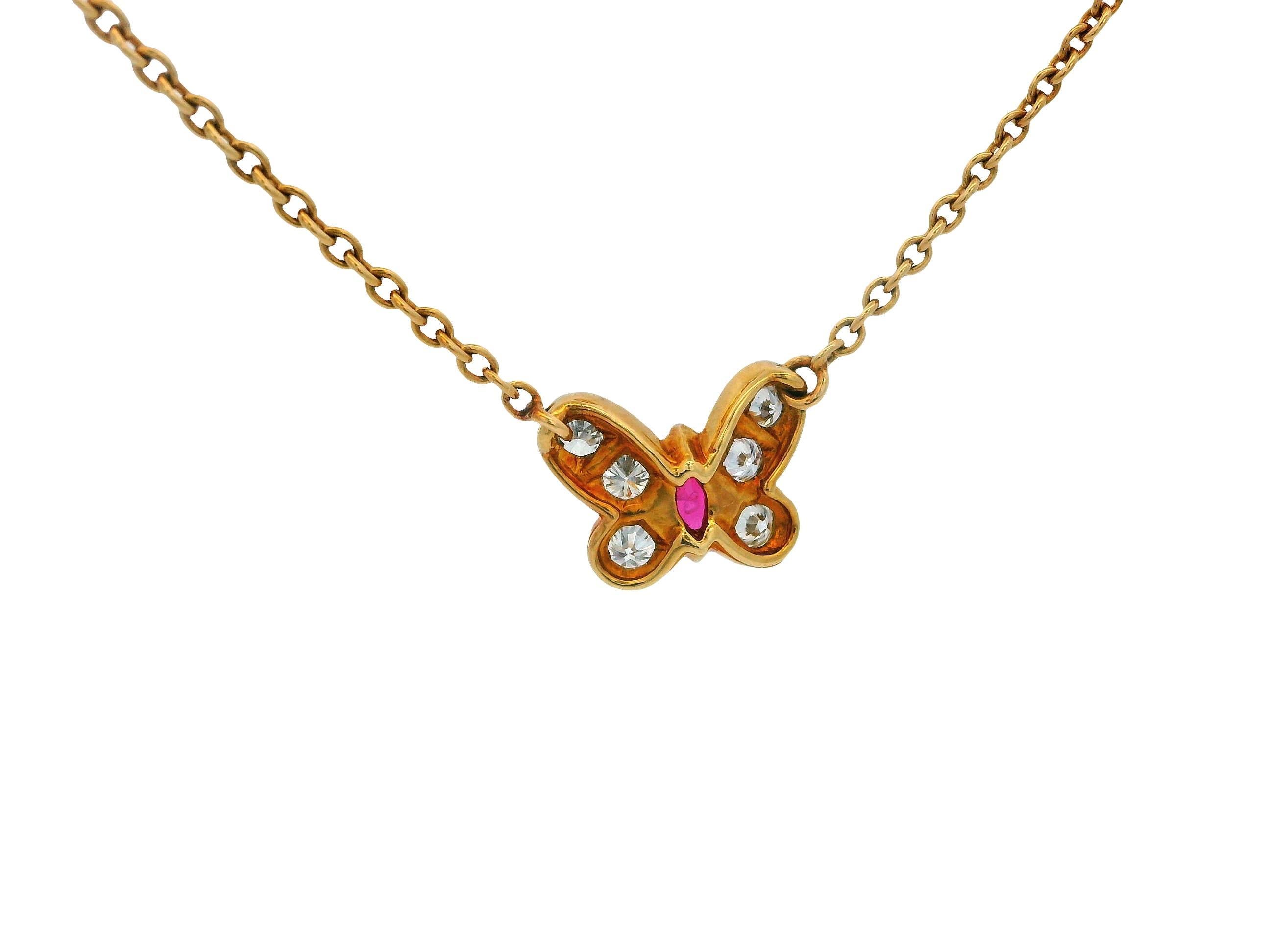 This exquisite pendant necklace features 0.55 carats of round white diamonds with VVS2 clarity and D color grade, enhanced by a 0.22-carat marquise-cut red ruby. Crafted from 18k gold, this beautiful piece was created by Van Cleef & Arpels in 1980