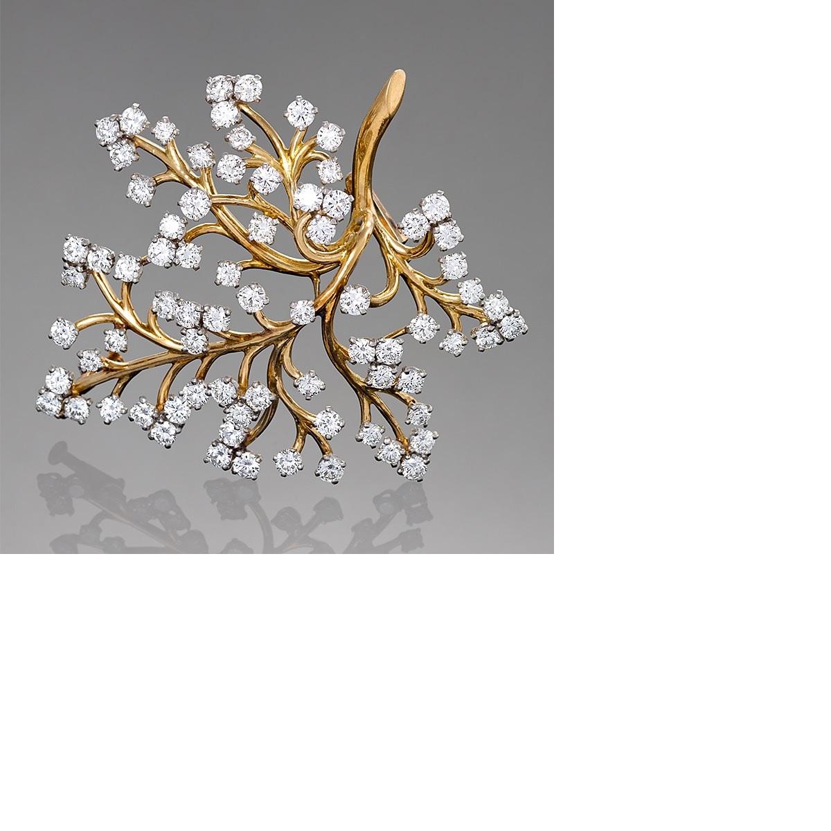 A French Mid-20th Century 18 karat gold 'Capillaire' brooch with diamonds by Van Cleef & Arpels. The brooch has 74 round diamonds with an approximate total weight of 6.00 carats, E/F/G color, VS clarity.  Circa 1959.

A similar brooch is pictured in