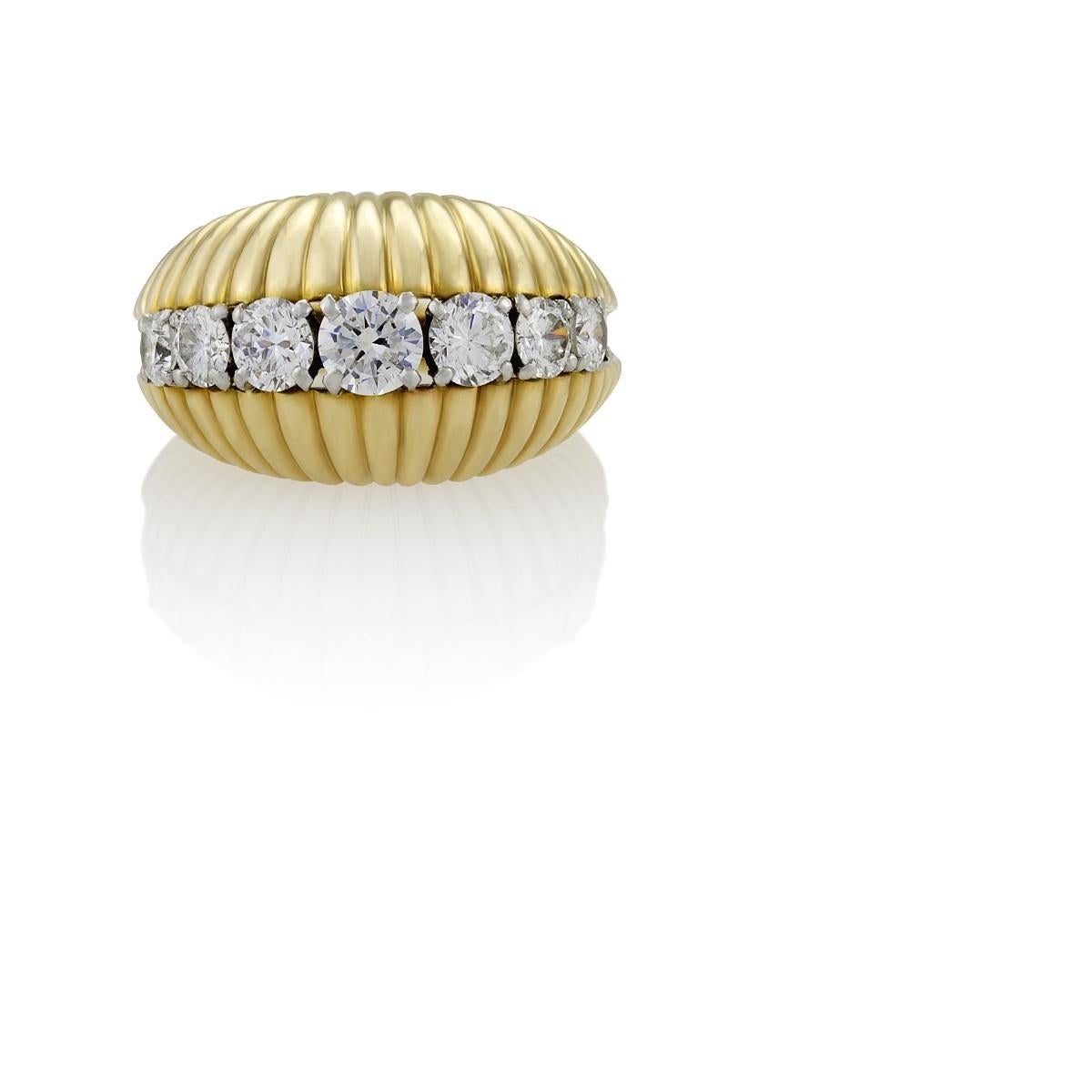 A Mid-20th century 18 karat gold and platinum ring with diamonds by Van Cleef & Arpels. The scalloped  bombé ring has 7 round-cut diamonds with an approximate total weight of 1.25 carats, G/H color, VS clarity. Circa 1960's.

Signed, “Van Cleef &