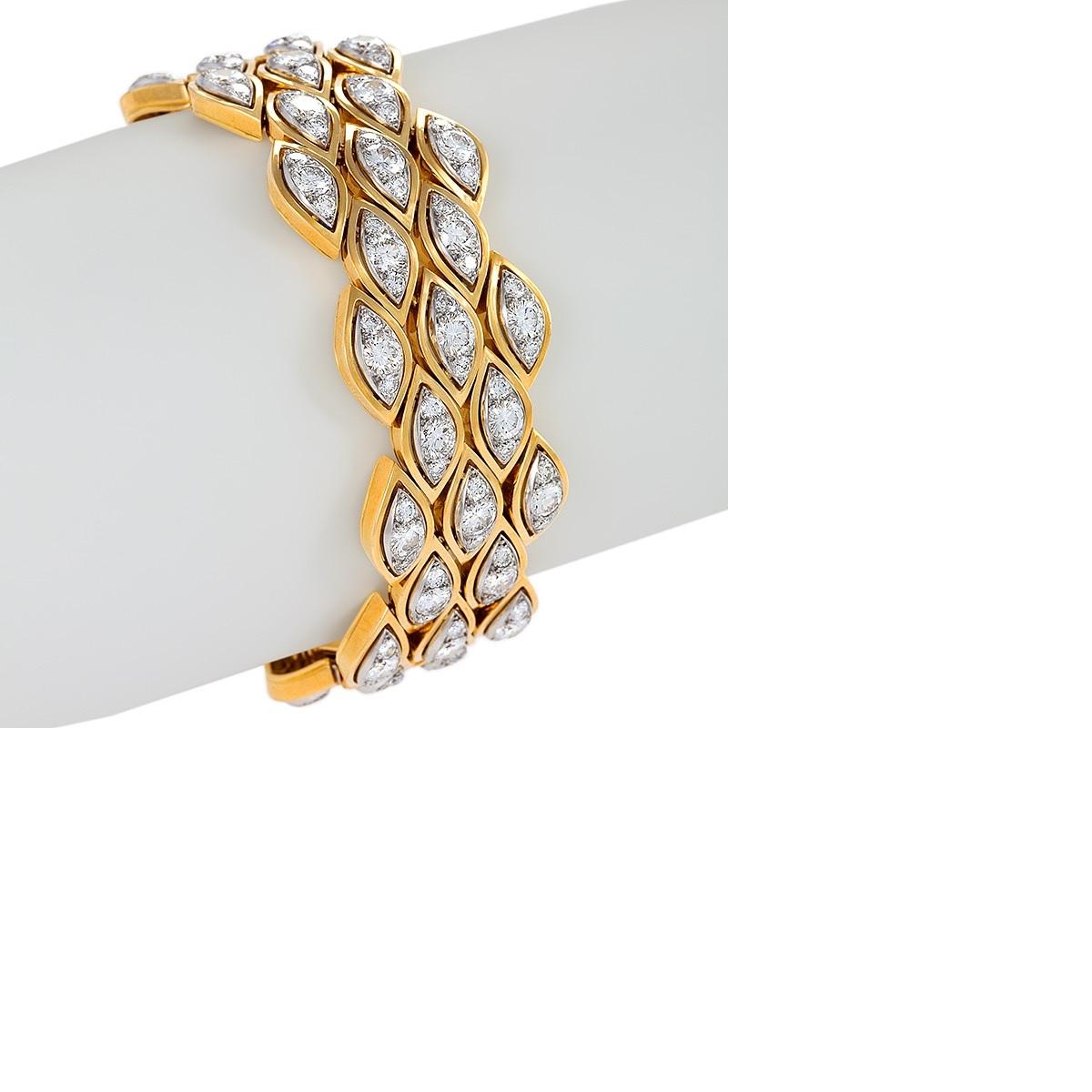 A French Mid-20th Century 18 karat gold and platinum bracelet with diamonds by Van Cleef & Arpels. The bracelet has 165 round cut diamonds with an approximate total weight of 15.00 carats, G/H color, VS clarity.  The bracelet is designed in a