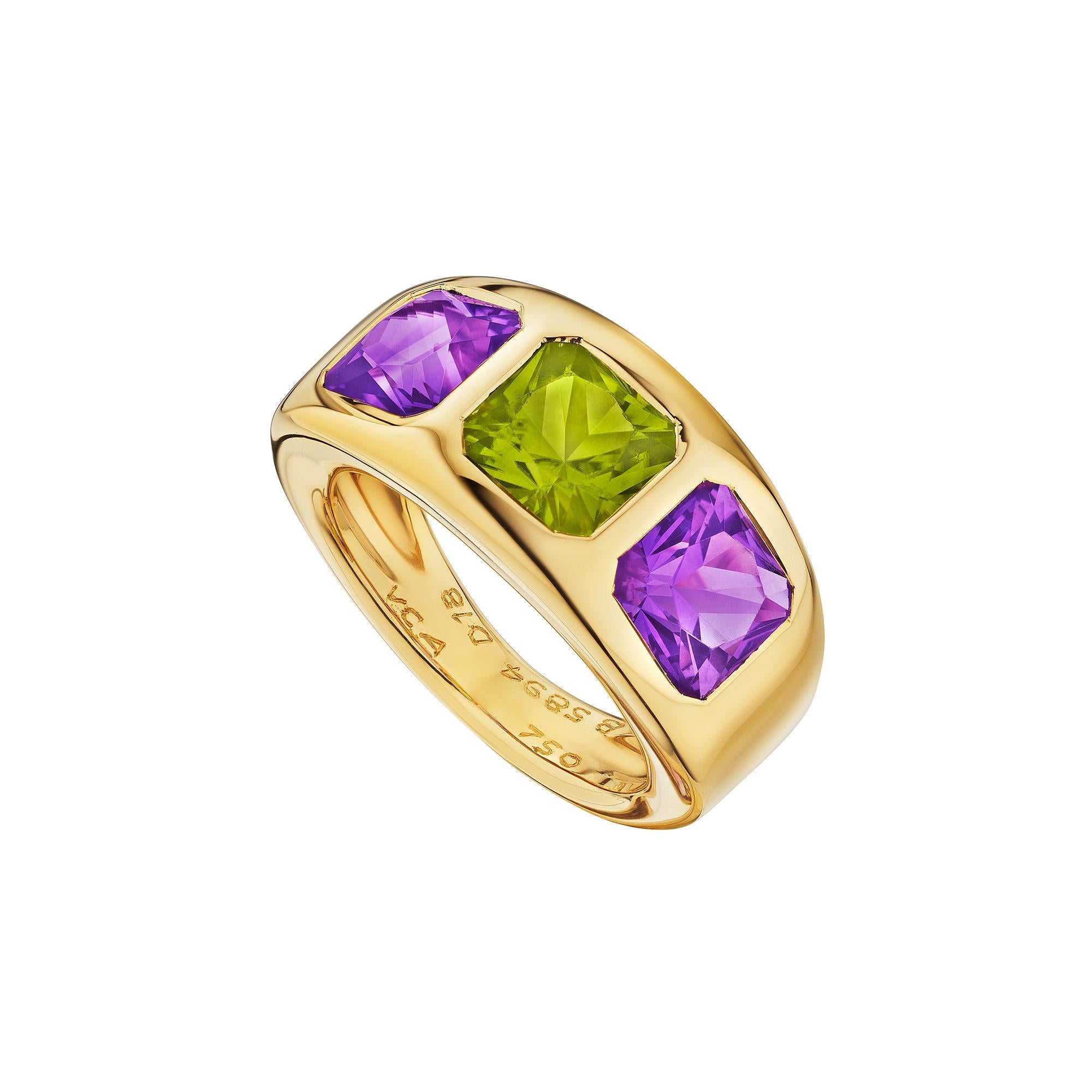 Three's company, and this Van Cleef & Arpels Paris modernist 18 karat polished yellow gold three stone ring is all the companionship you will need.  With one center cushion cut peridot gemstone and two amethyst side stones, this exciting