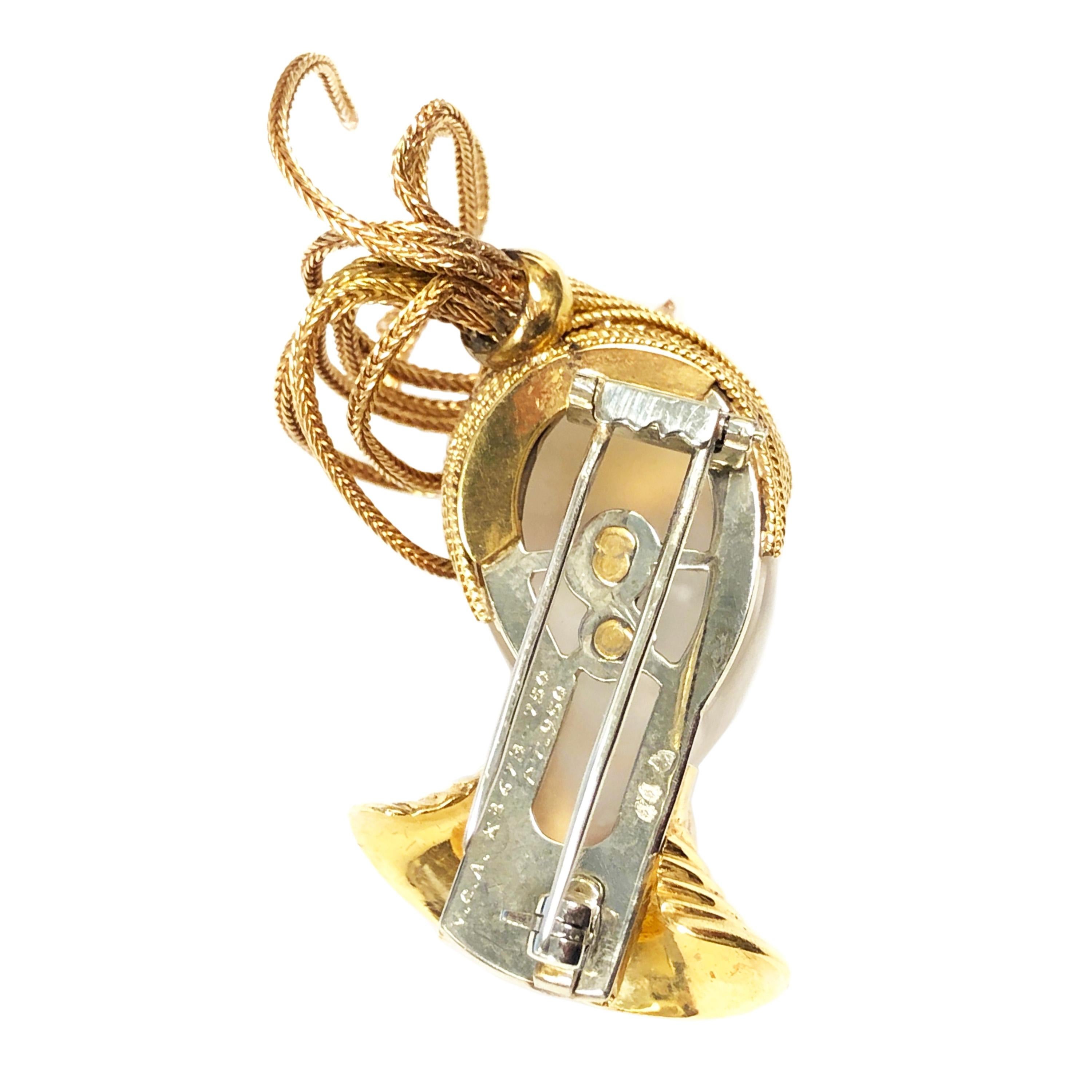 Circa 1960s Van Cleef and Arpels Paris 18K Yellow Gold and Platinum Whimsical Head Brooch, measuring 1 1/2 inches in length. The Frosted Rock Crystal Head Features Gem set Eyes and Mouth, a Gem set necklace and Gold articulated flowing hair. Double