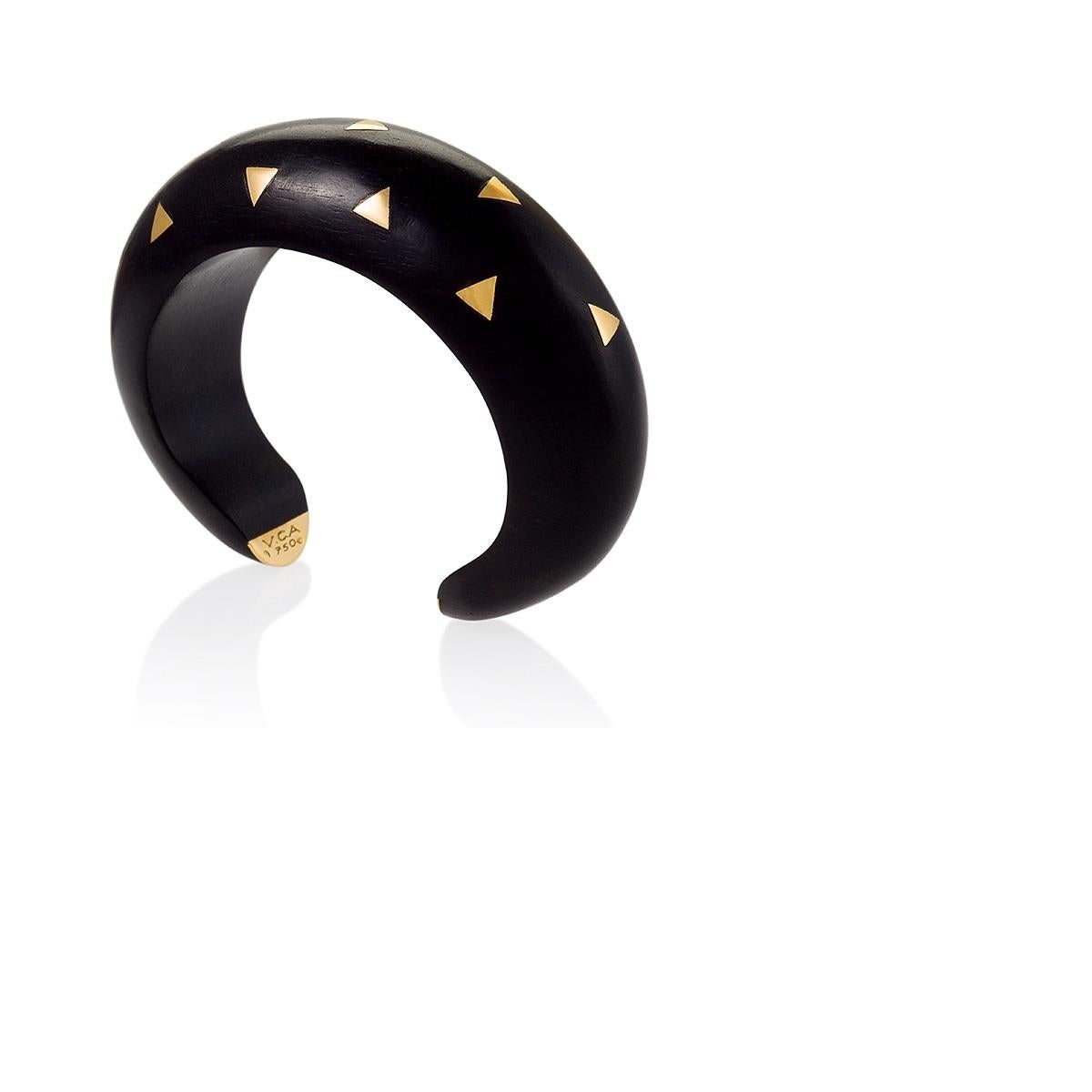 A French Late-20th Century ebony cuff with 18 karat gold accents by Van Cleef & Arpels. Van Cleef & Arpels have been designing and making wood jewelry since the 1920's.  Circa 1987-93.

Similar from the collection pictured in Van Cleef & Arpels, by