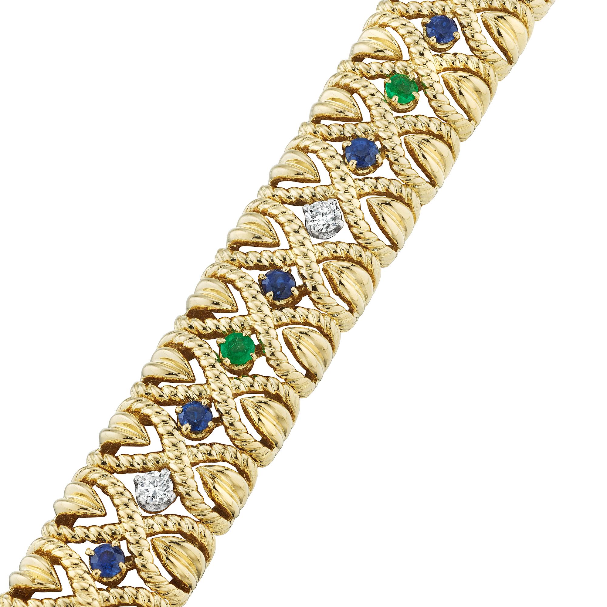 Designed by Van Cleef & Arpels Paris in 1961, this mid-century emerald, sapphire, diamond gold 'X' bracelet, is the ultimate in timeless grace.  Worn alone or stacked with other bracelets, this collectible jewel is irresistible.  Circa 1961.  Total
