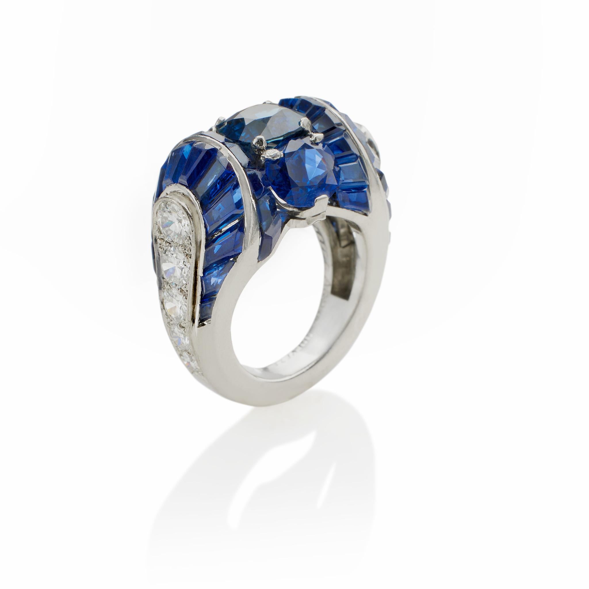 Created in the late 1930s by Van Cleef & Arpels Paris, this Burma sapphire and diamond ring is mounted in platinum. The ring centers three vertically-set cushion-cut sapphires, weighing 1.96, 1.21, and 1.20 carats, flanked by two canted rows of