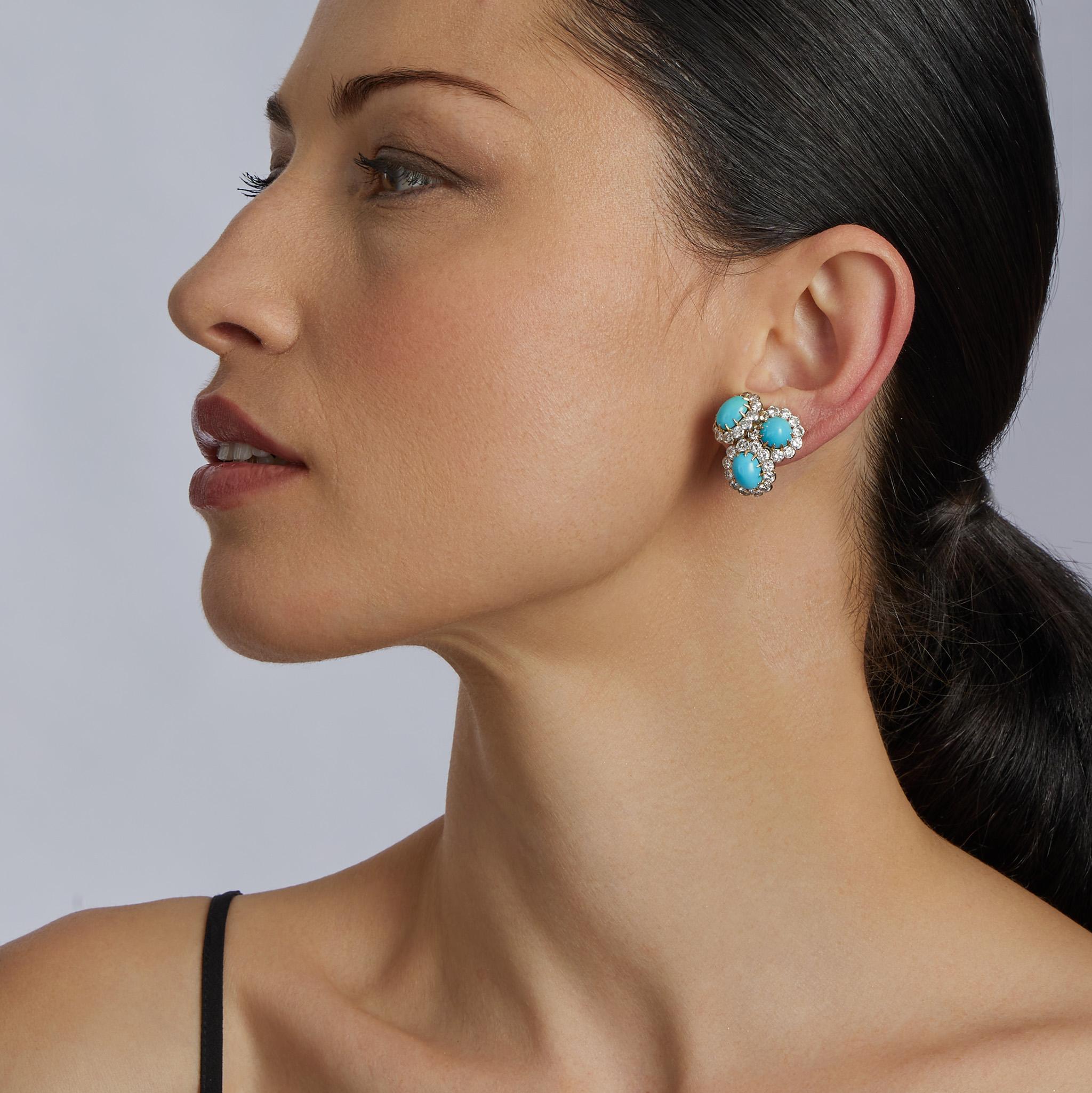 Dating from the 1970s, these Van Cleef & Arpels Paris clip earrings are composed of turquoise and diamonds set in 18K gold and platinum. The clip earrings are composed of a layered, bombé cluster of three cabochon turquoise, each framed by round