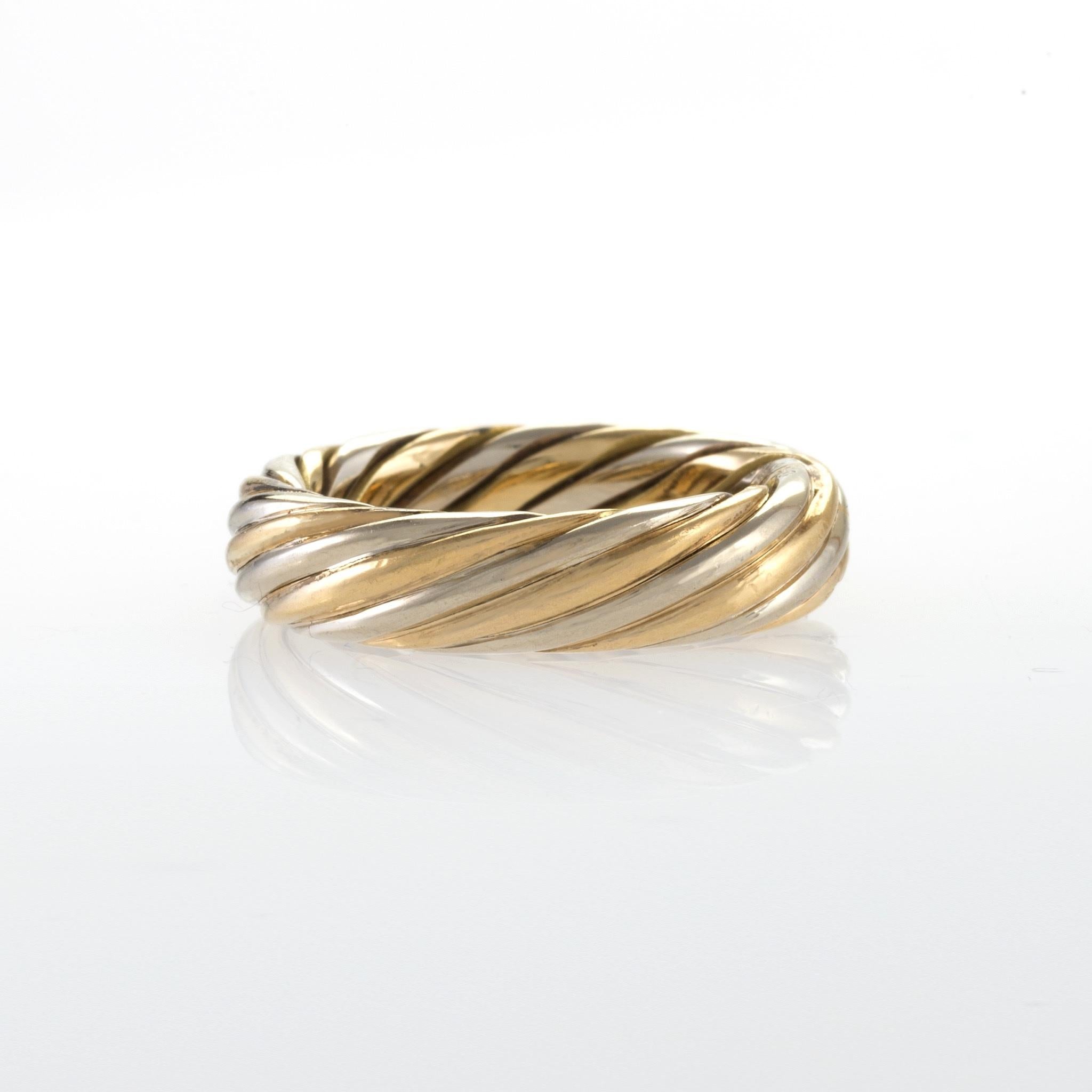 A French Late-20th Century 18 carat gold ring by Van Cleef & Arpels. The polished yellow and white gold ring is designed in a multi-strand twisted motif.  Circa 1970 - 80's.

Signed, 