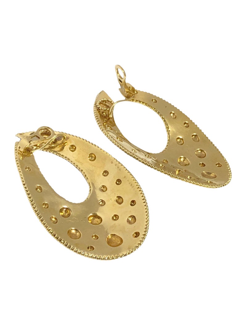 Circa 1980 Van Cleef & Arpels Paris Large and impressive 18K Yellow Gold Earrings, measuring 2 3/4 inches in length, 1 5/8 inches wide and weighing 49 Grams, having a textured & hammered design with applied Rondelles and fine beaded borders. Omega