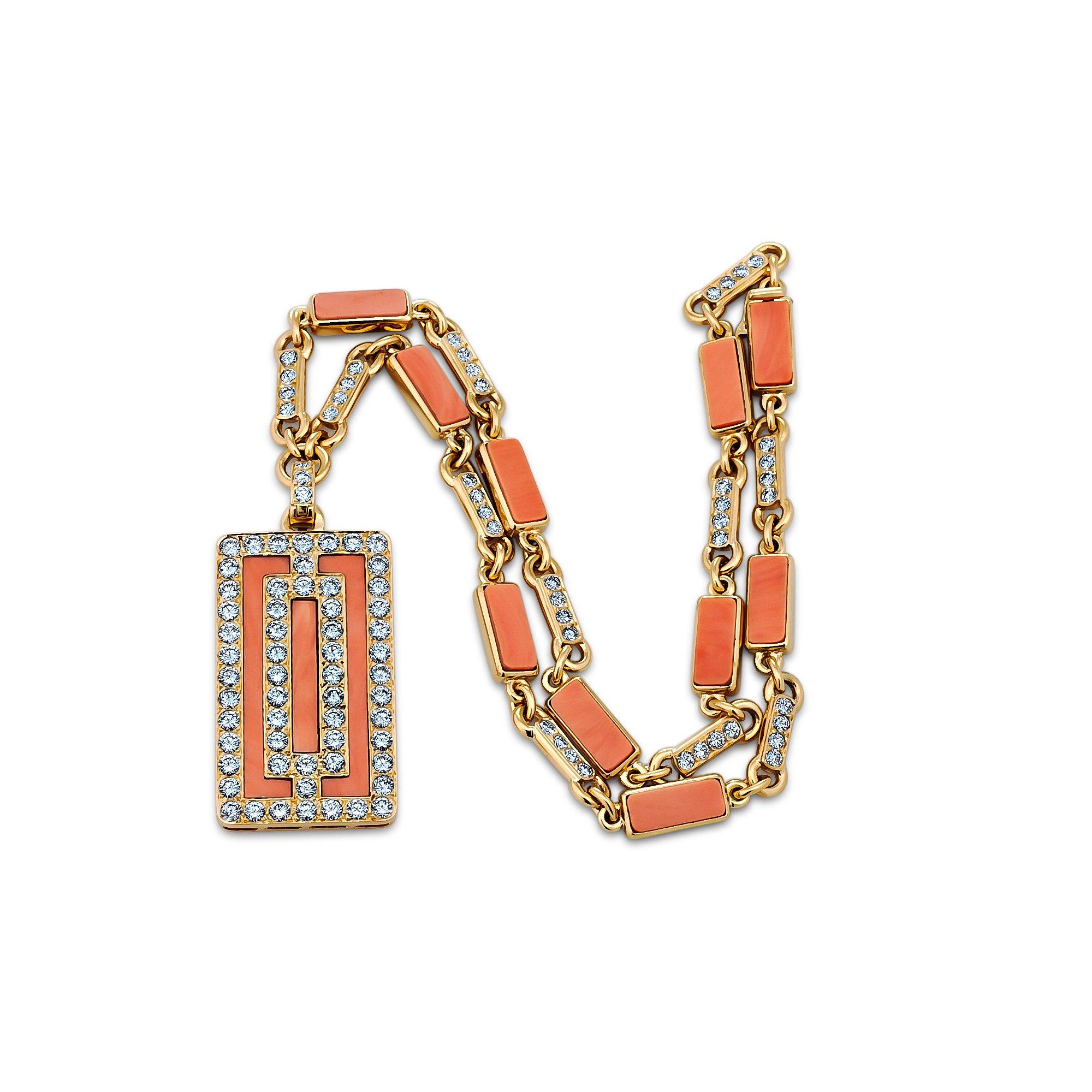 This sleek and graphic vintage diamond and coral pendant necklace, designed by Van Cleef & Arpels Paris, is filled with visual energy.  The rectangular pendant and coordinating link chain are designed with the perfect combination of lusciously cool