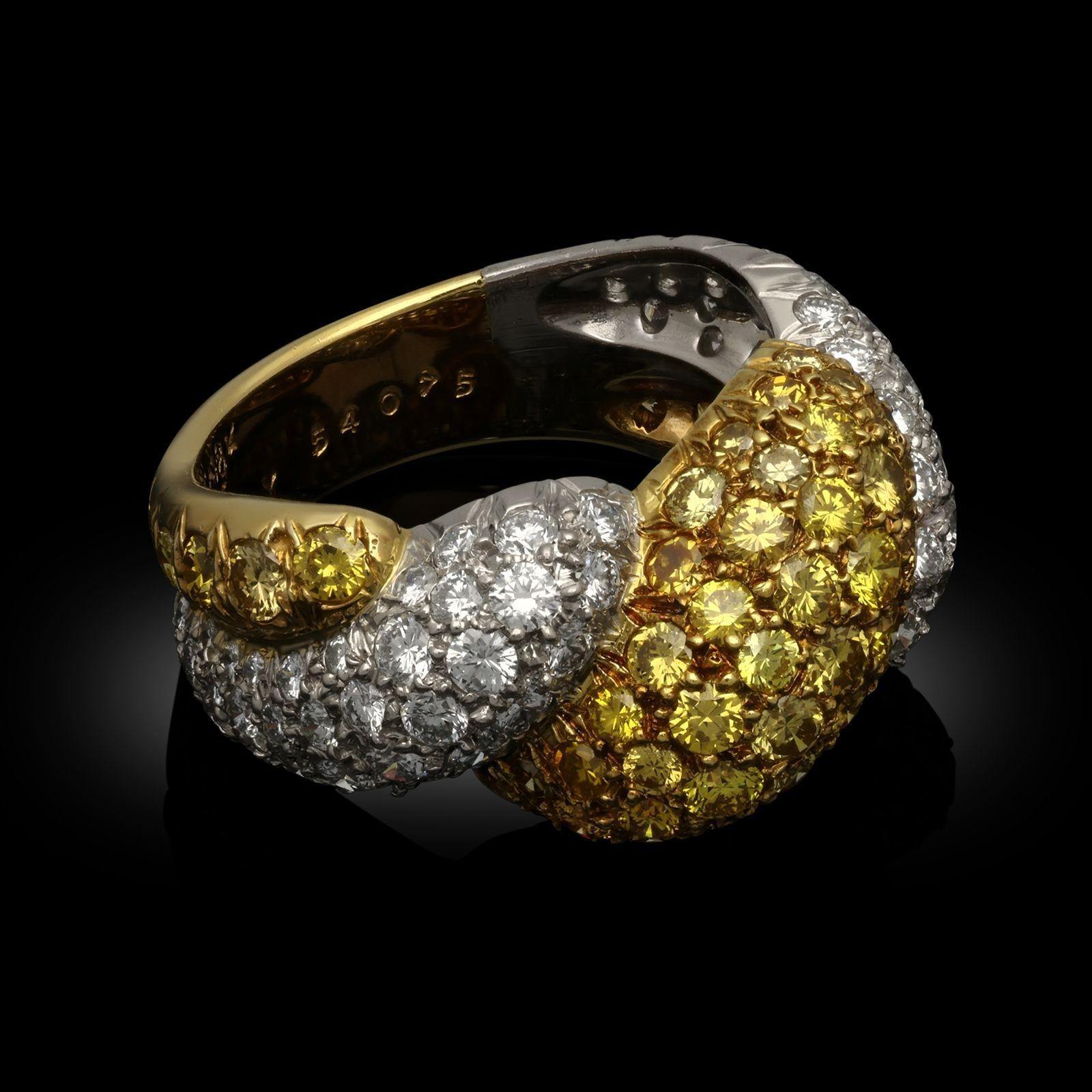 A striking yellow and white diamond bombe dress ring by Van Cleef & Arpels c.1980s, the ring with a high domed profile and shaped wrap-over twist design, formed of a band of pavé set round brilliant cut yellow diamonds set in 18ct yellow gold