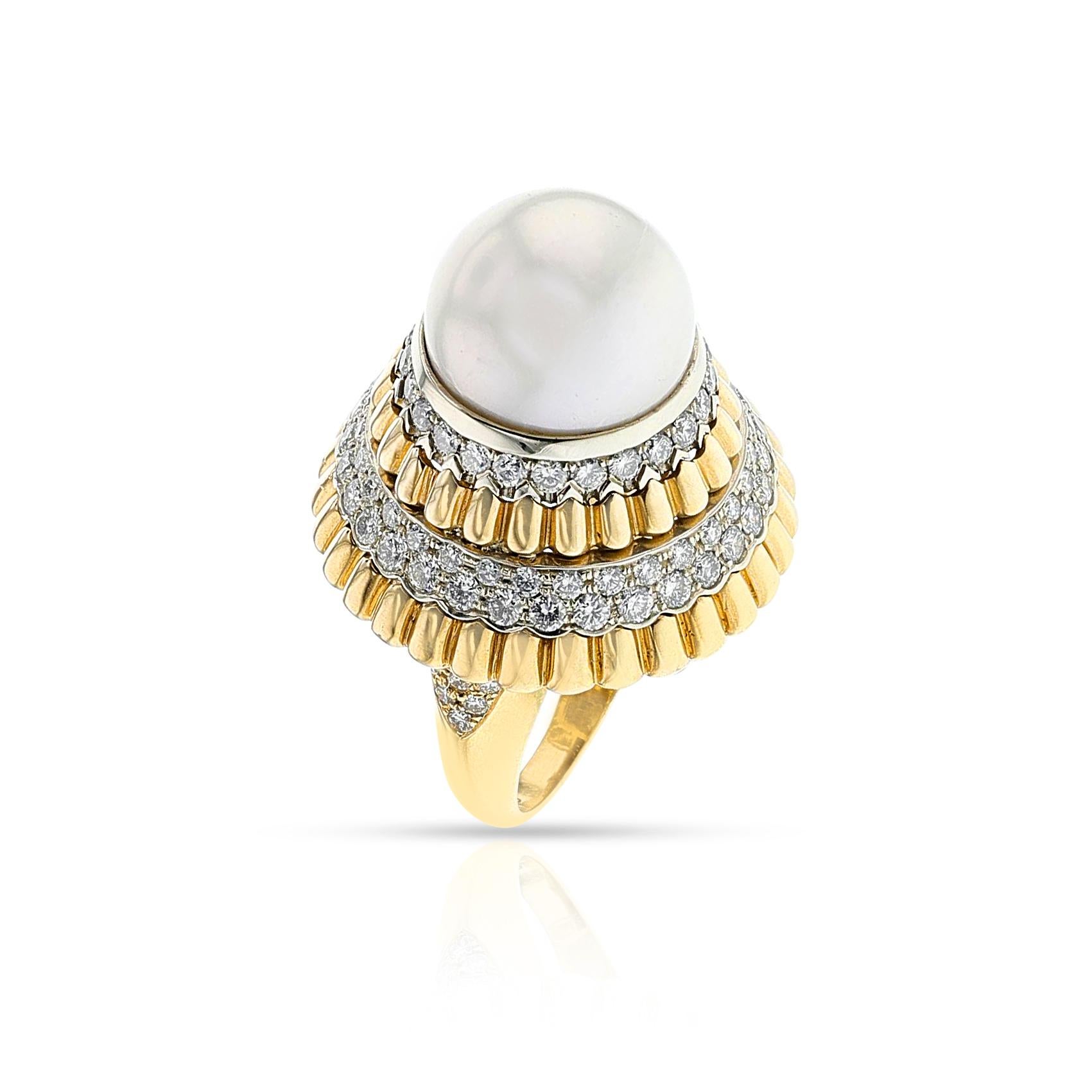 A Van Cleef & Arpels Pearl and Diamond Ballerina Cocktail Ring made in 18k Yellow Gold. The pearl is 15MM. The total weight is 27.35 grams. Ring Size US 7.75. Signed, numbered, French marks.
