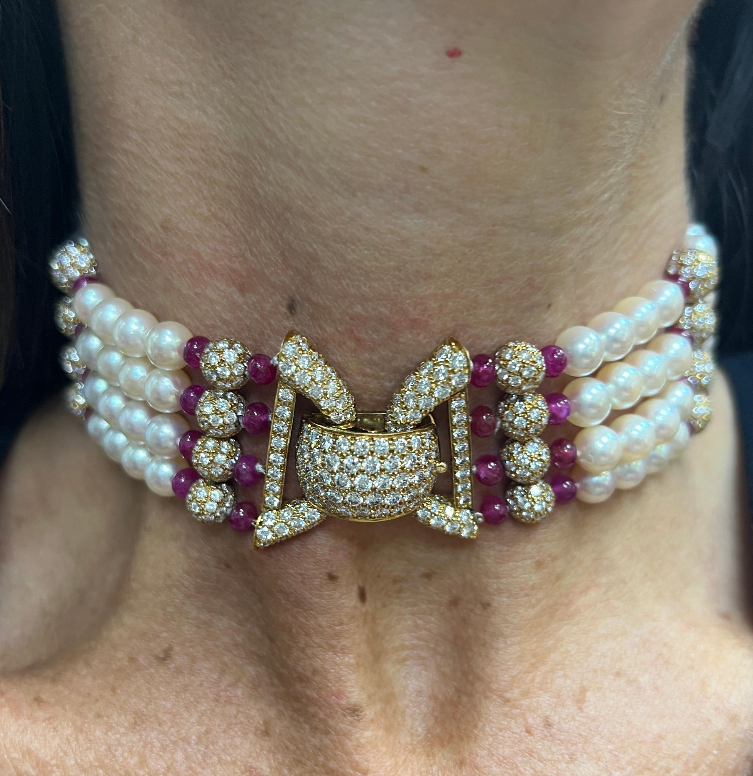 Van Cleef & Arpels Pearl Ruby And Diamond Choker

A choker necklace featuring four strands of  graduated cultured pearls, measuring approximately 9.78 mm to 6.80 mm.  Set with ruby beads and pave diamond spheres with a diamond clasp.

Measurements: