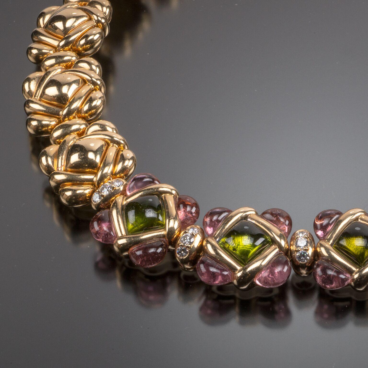Van Cleef & Arpels has reworked their classic clover design in delicate pastel shades in this 18k gold hinged choker. The five central clover-form links feature cabochon peridots edged with tourmalines and are separated by diamond accented