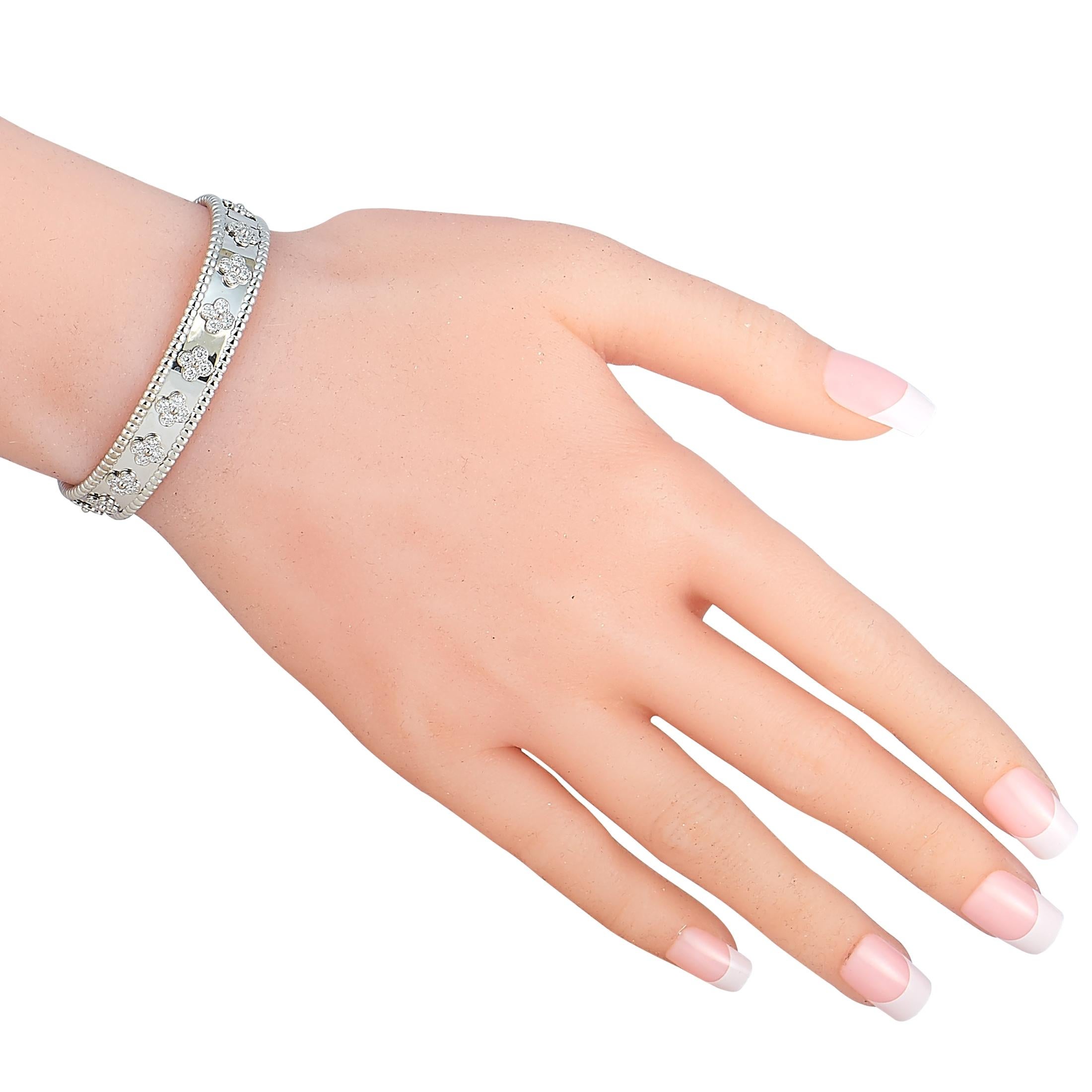 The Van Cleef & Arpels “Perlée” bracelet is made of 18K white gold and boasts clover motifs embellished with diamonds. The bracelet weighs 31.7 grams and measures 6.65” in length.

This jewelry piece is offered in estate condition and includes the