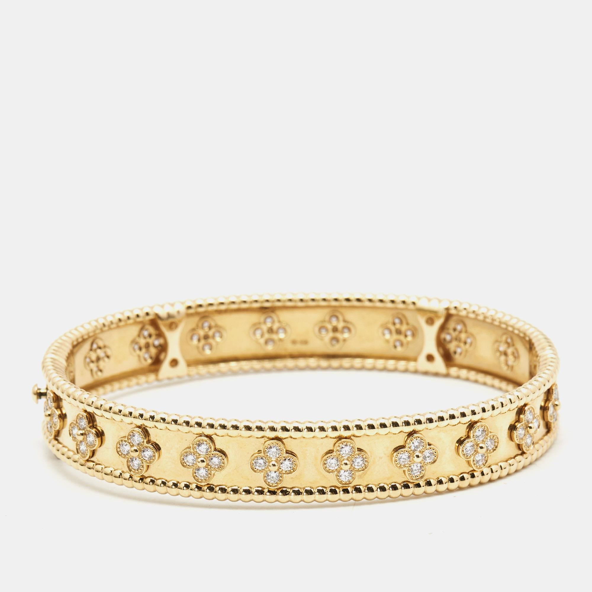 This Van Cleef & Arpels Perlée Sweet Clovers bracelet is a fine example of VC's prowess in jewelry making. It is sculpted using 18k yellow gold and beautified with rows of signature Perlée beads and diamond-studded clover motifs. The jewel is a