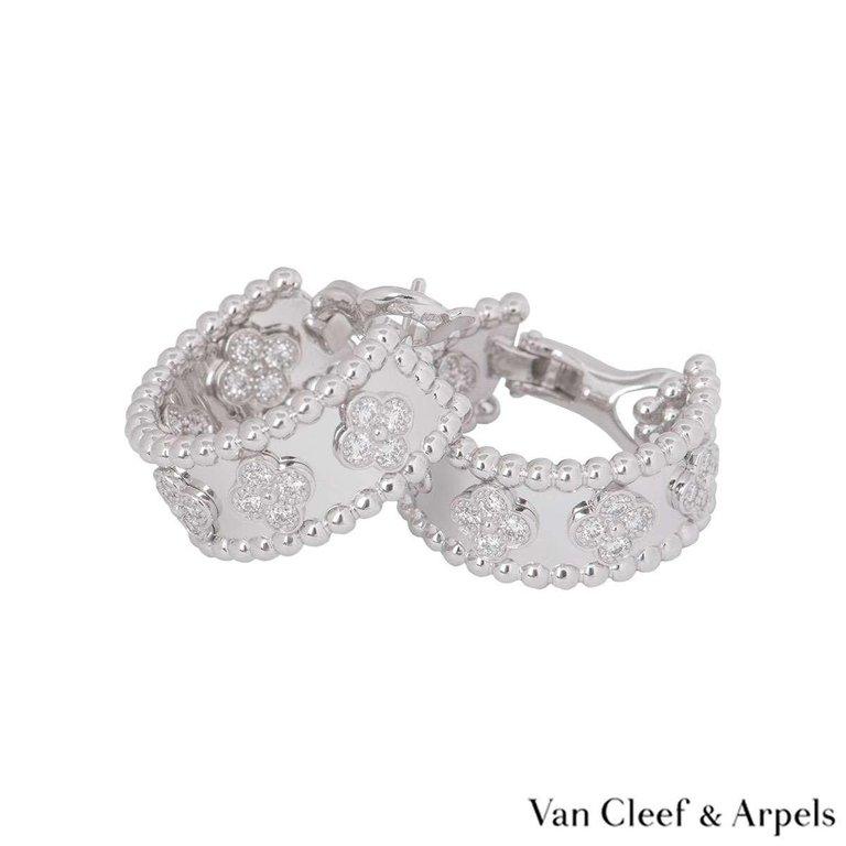 The creations in the Perlée™ clovers collection are adorned with precious clover motifs - Van Cleef & Arpels' symbol of luck. They are graced by a golden bead at their center.
An 18k white gold pair of diamond hoop earrings by Van Cleef & Arpels