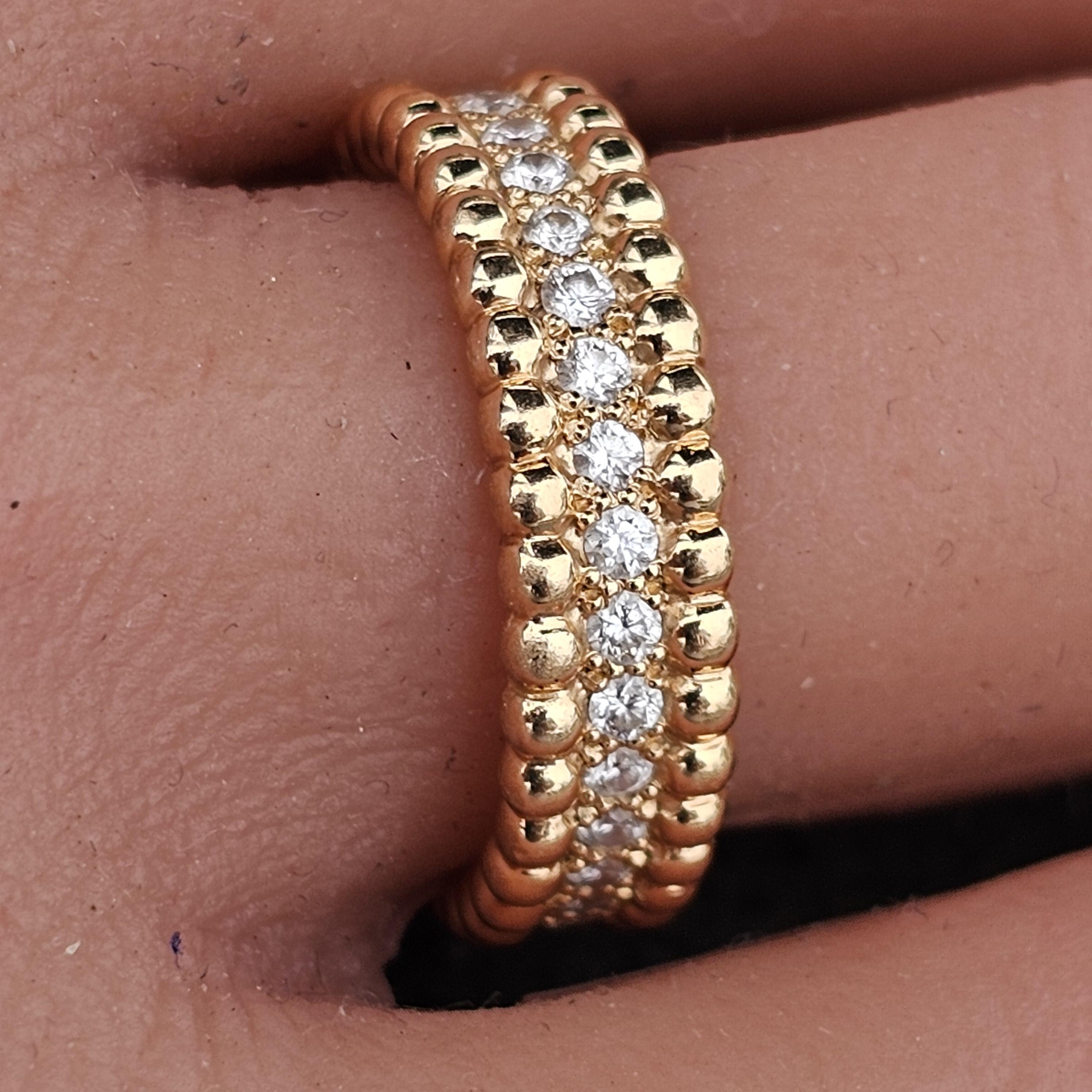 This exquisite Van Cleef & Arpels Perlee 1 row diamond band ring features a captivating design with a row of round, white diamonds. Crafted from luxurious 18k rose gold, the ring exudes elegance and sophistication. The diamonds, totaling 0.49
