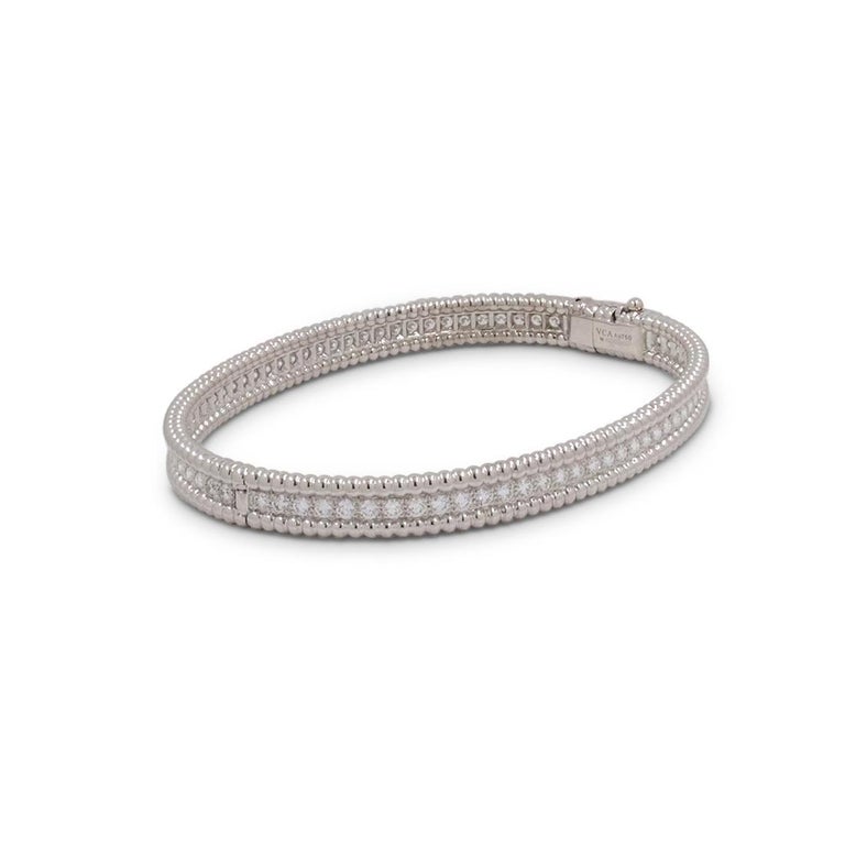 Authentic Van Cleef & Arpels 'Perlée' bracelet crafted in 18 karat white gold features a single row of high-quality round brilliant cut diamonds weighing an estimated 2.16 carats total weight (E-F, VS). Signed VCA, Au750, M, with serial number. The