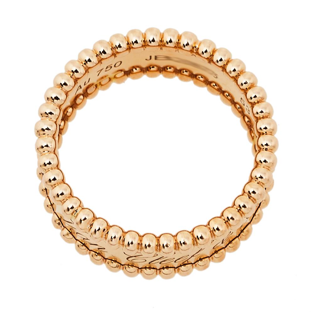 This creation from Van Cleef & Arpels is meant to project a modern look. The Perlée Signature ring has been luxuriously crafted from 18k rose gold and lined with beads along the contours. Set beautifully within the ring are neat engravings of the