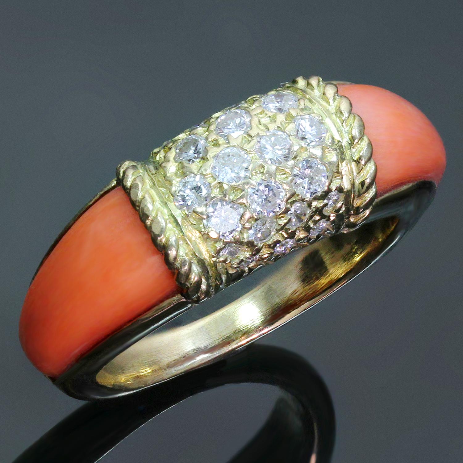 This rare vintage Van Cleef & Arpels ring from the classic Philippine collection is crafted in 18k yellow gold and features an estimated 0.50 carats of natural round diamonds pave-set in the center complemented with pink corals on the sides. Circa