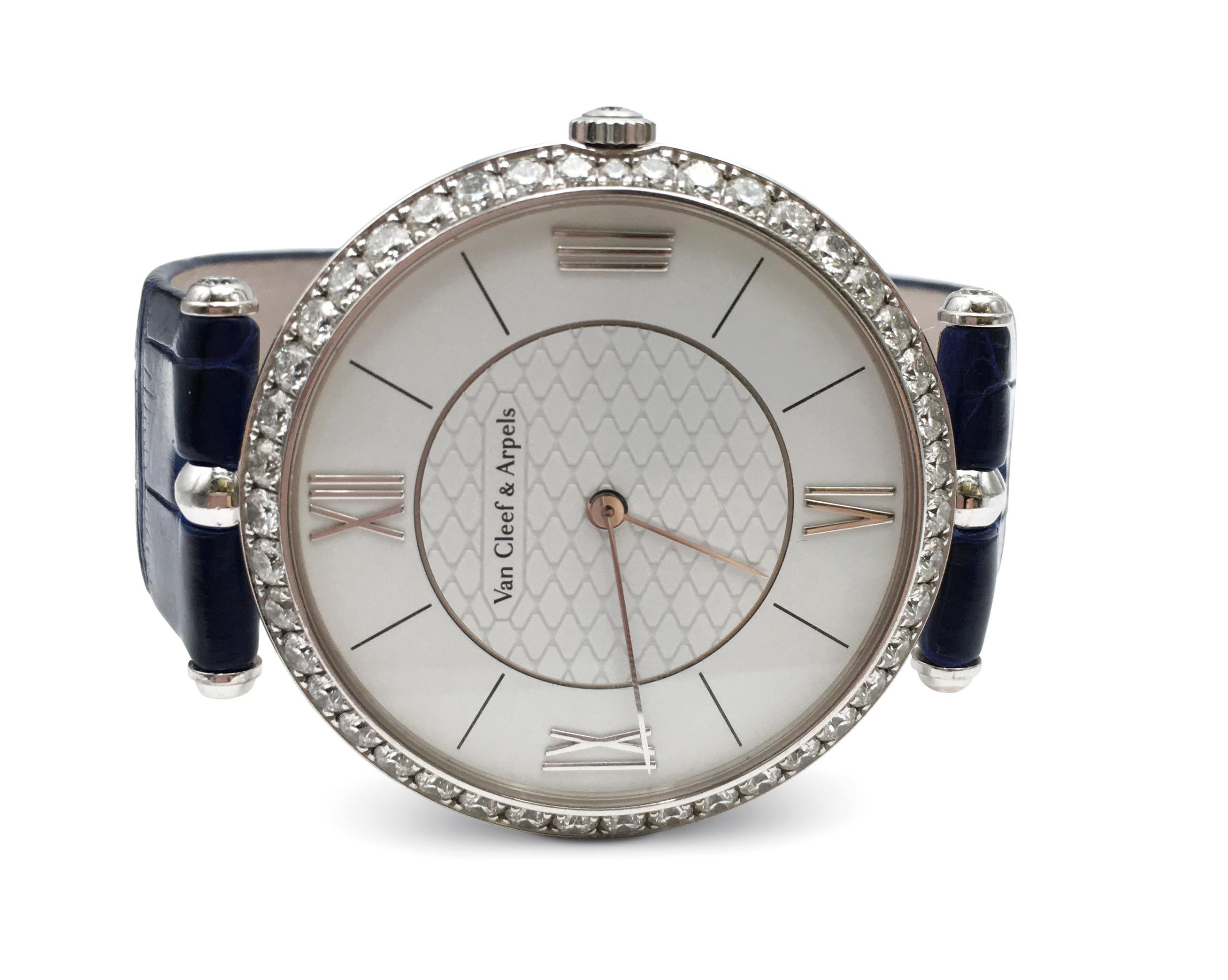 Authentic sophisticated Van Cleef & Arpels watch designed by Pierre Arpels. The watch is crafted in 18 karat white gold and features a thin 38 mm case held by two central attachments. The bezel is set with high-quality round brilliant cut diamonds