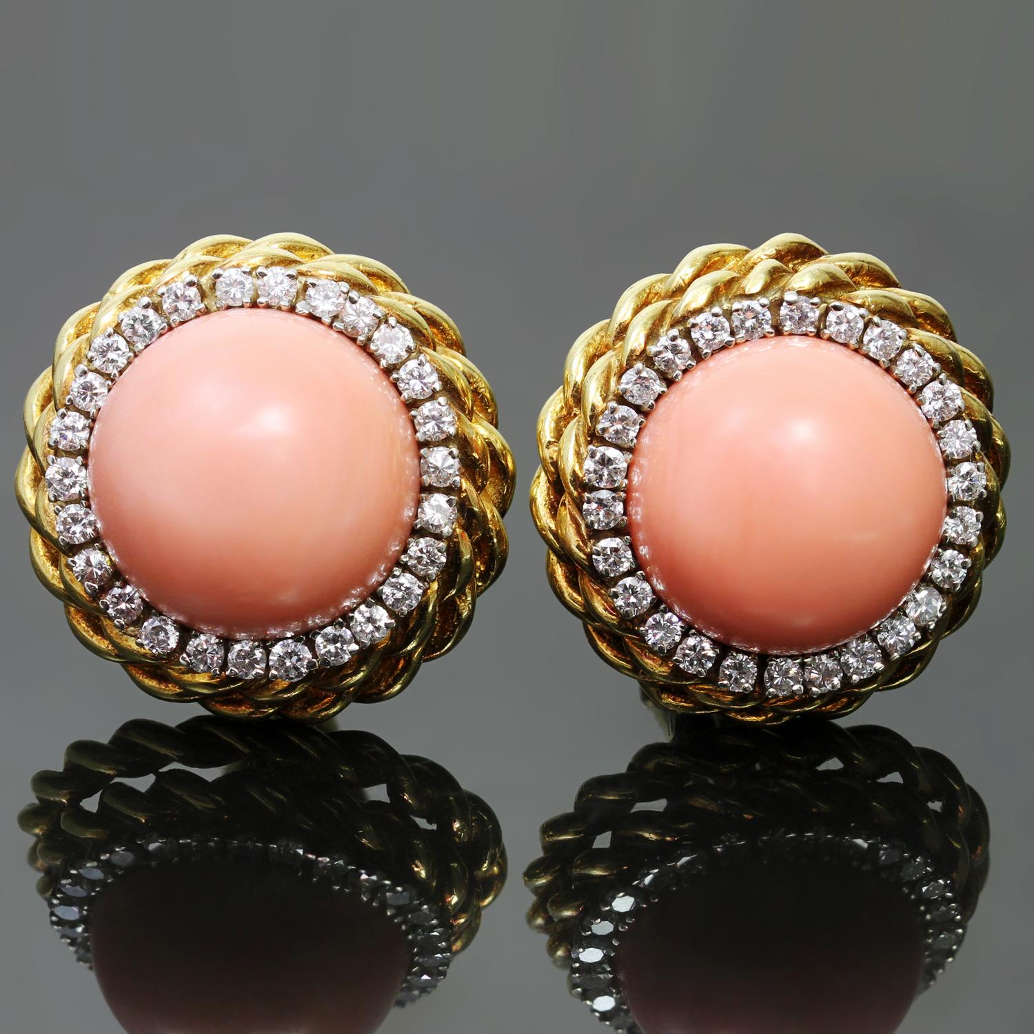 These gorgeous vintage Van Cleef & Arpels 18k yellow gold clip-on earrings feature round cabochon corals measuring 8.70mm x 15.00mm x 15.30mm, surrounded with 52 round brilliant-cut diamonds of an estimated 1.85 carats. Made in United States circa