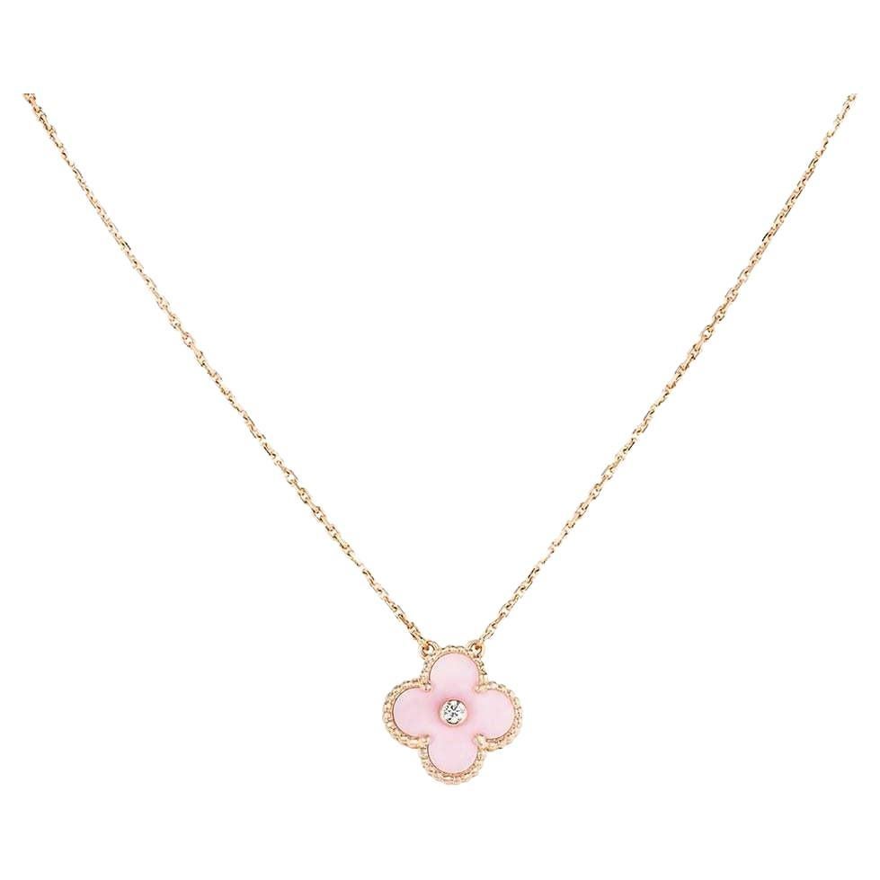 A limited edition 18k rose gold pink porcelain and diamond Van Cleef & Arpels Vintage Alhambra pendant, from the 2015 Holiday collection. The pendant features the iconic beaded edge 4-leaf clover motif with a Pink Sèvres porcelain inlay. Van Cleef &